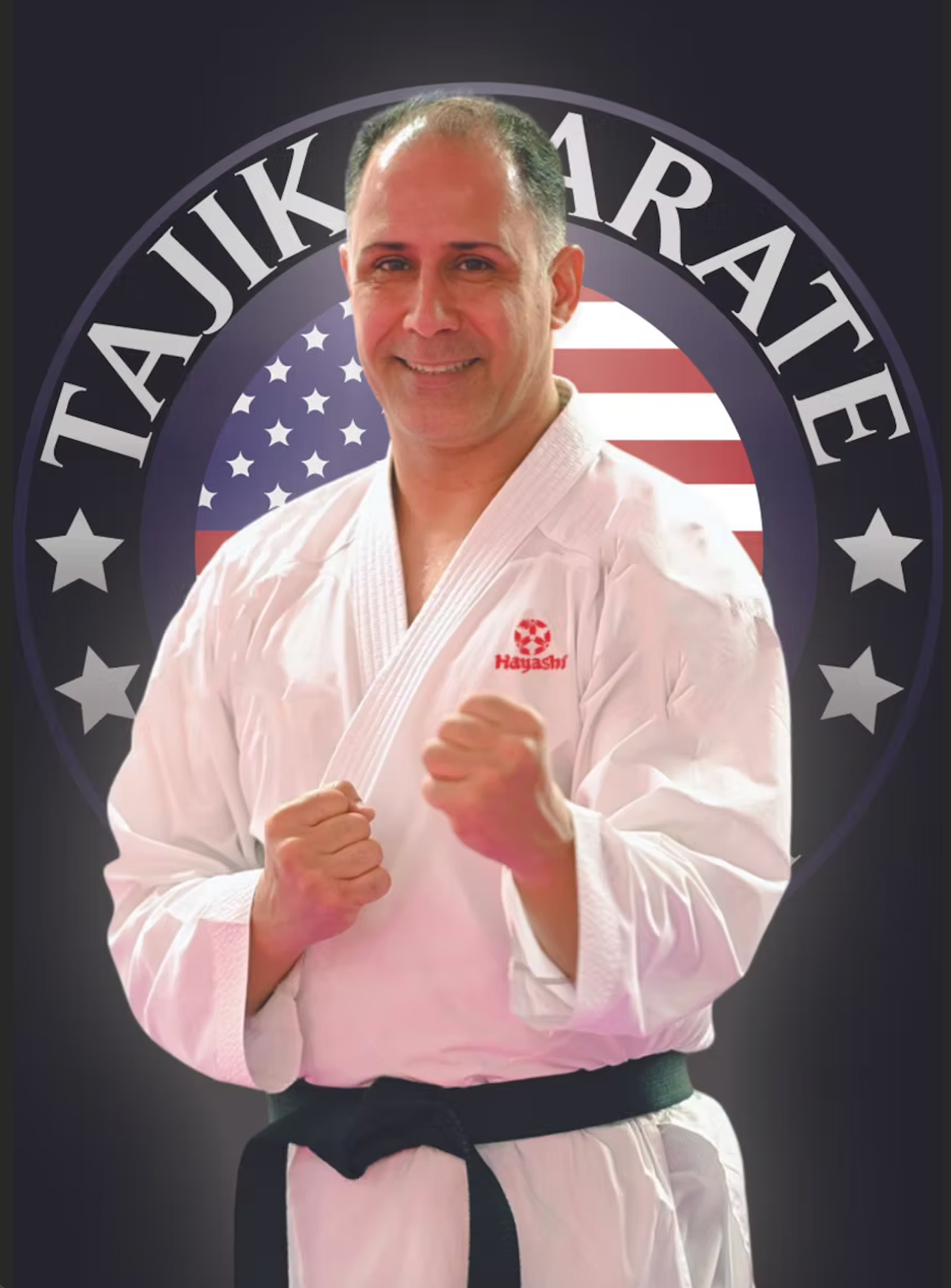 Man in a white martial arts gi with a black belt, standing confidently with fists clenched in front, in front of a logo that reads 'TAI JUIKARATE' with an American flag background.