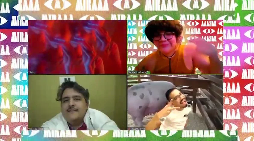 Four people participating in a virtual video call with a colorful background featuring white, red, green, purple, and blue eye logos and the text 'AMAA' repeatedly. The participants are smiling and making gestures.