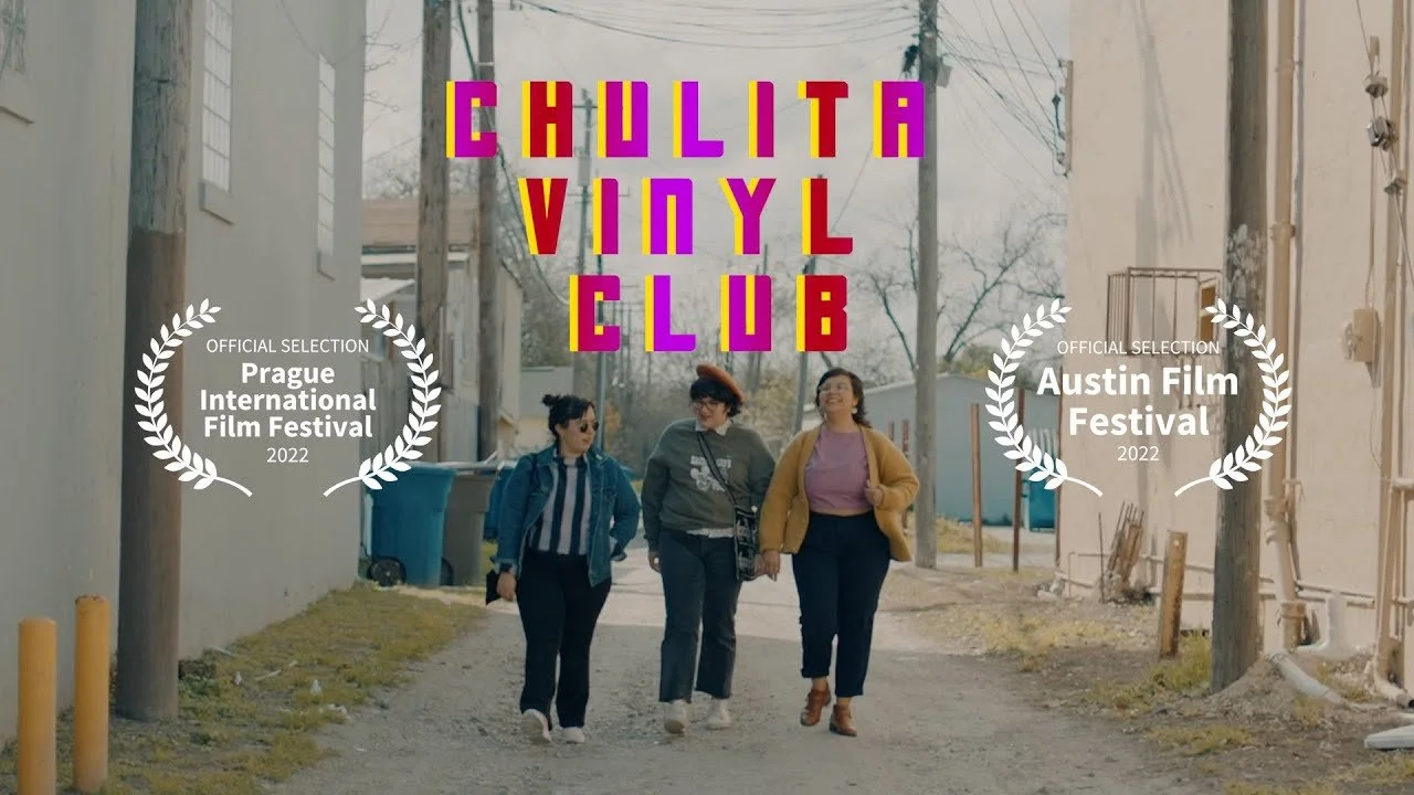 Three women walking down an alleyway, smiling and talking.