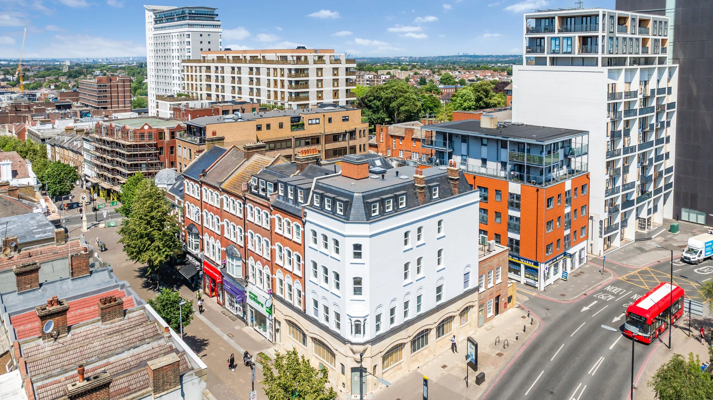 A mixed-use development in Sutton, South London, comprising one commercial unit across the ground and basement floors and nine luxury apartments spread over four upper floors. The scheme is facilitated by a new mansard roof extension and a tiered rea