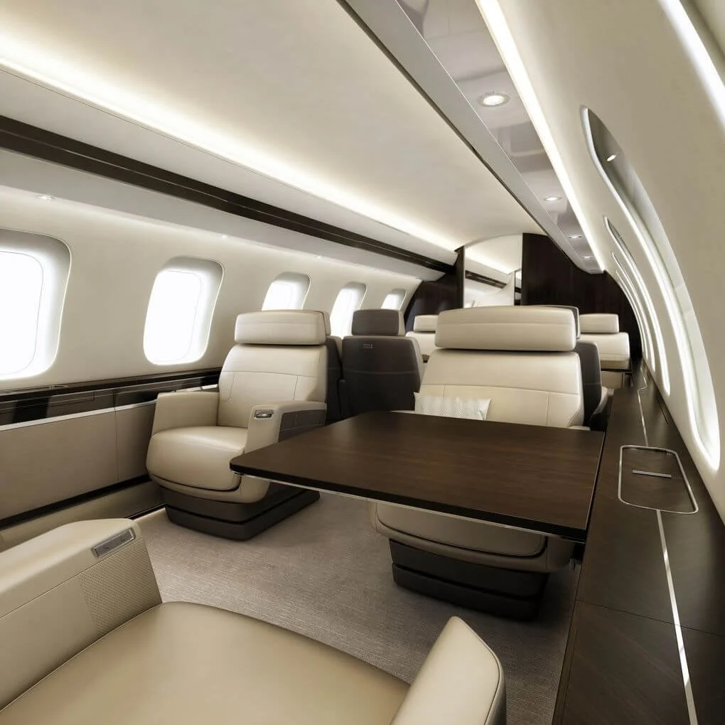 Bombardier Global 7500 – Ultra Long-Range Luxury Private Jet interior with beige leather seating, wood finishes, and large windows.