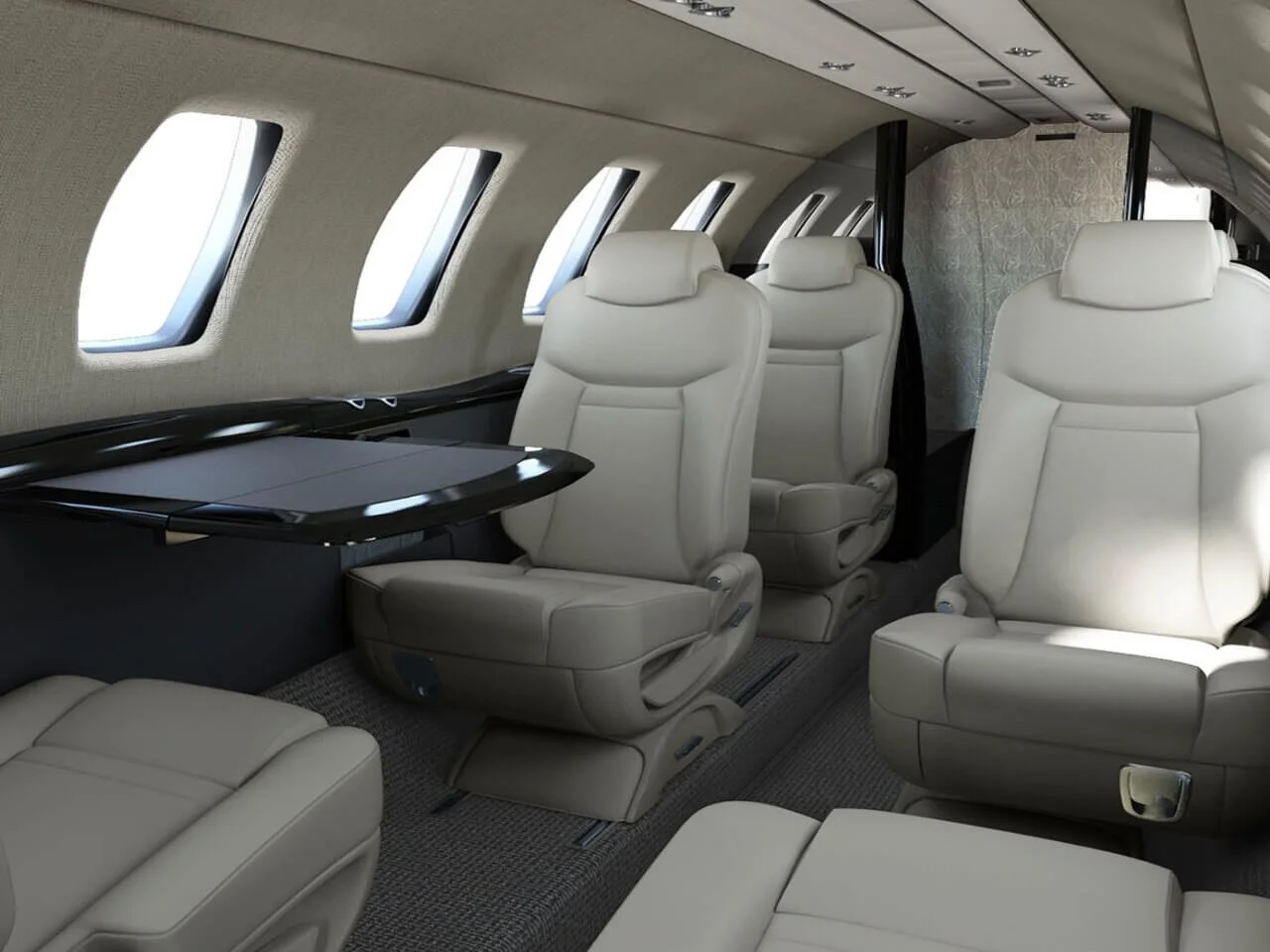 Interior of a private jet Cessna Citation CJ4 with beige leather seats and oval windows.