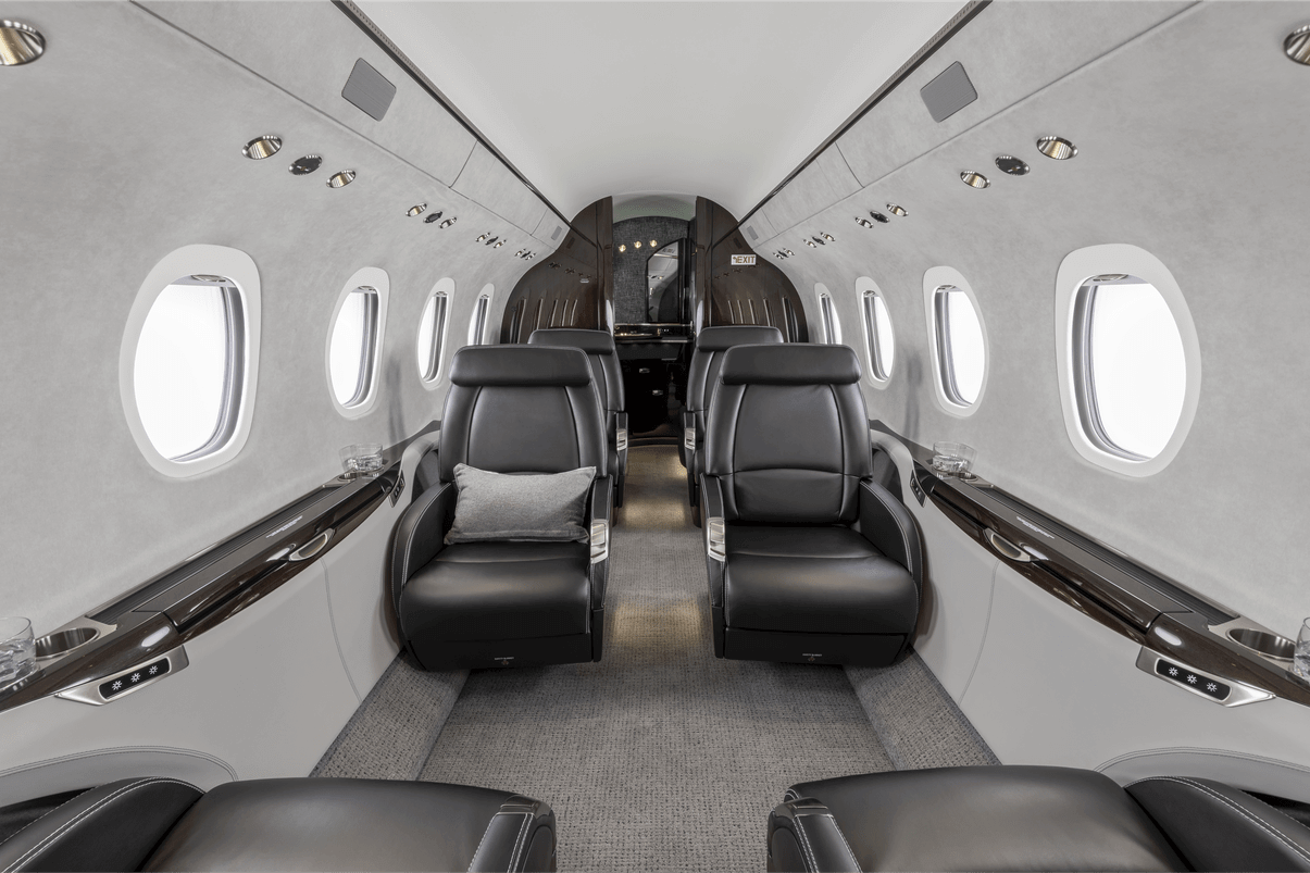 Interior of Cessna Citation Latitude Private Jet with leather seats and large windows.