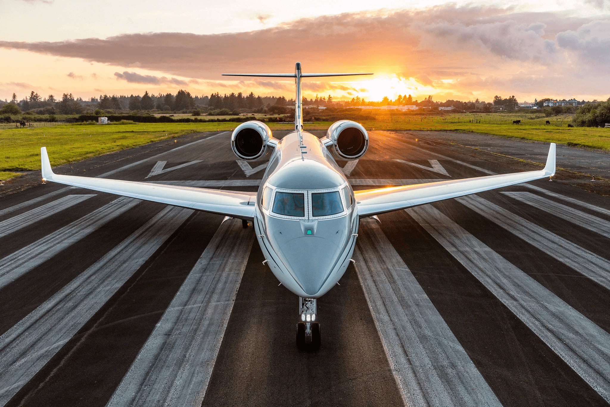Private jet on a runway during sunset