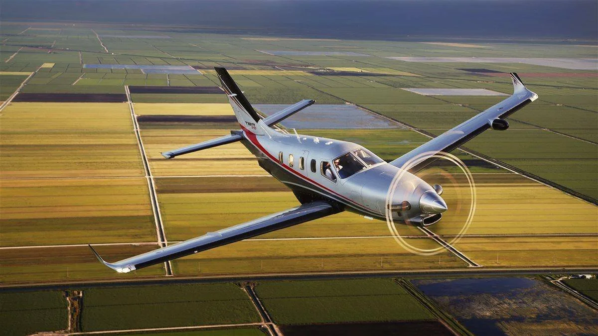 Daher TBM 940 flying over agricultural fields