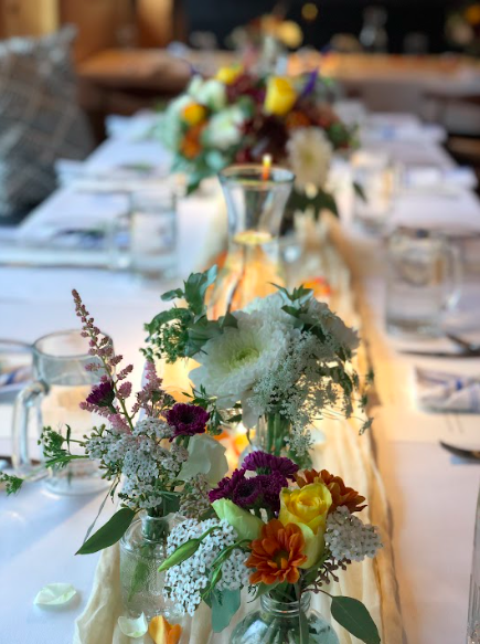 Private wedding event table. Custom designer floral arrangement. boho centerpiece Alaskan wedding. Weddings in Alaska. High end Alaska weddings. Alaska destination wedding venue.