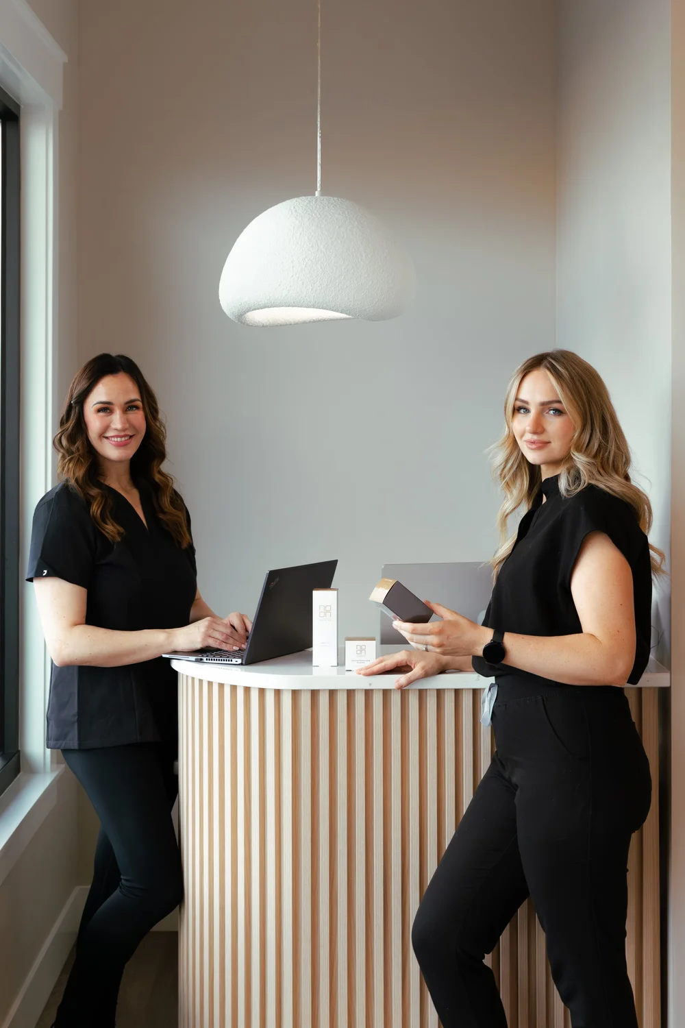 Liliya Yanyk, RN, and Emily Selkirk, LE, at the front desk of SKYN, a med spa in Star, Idaho