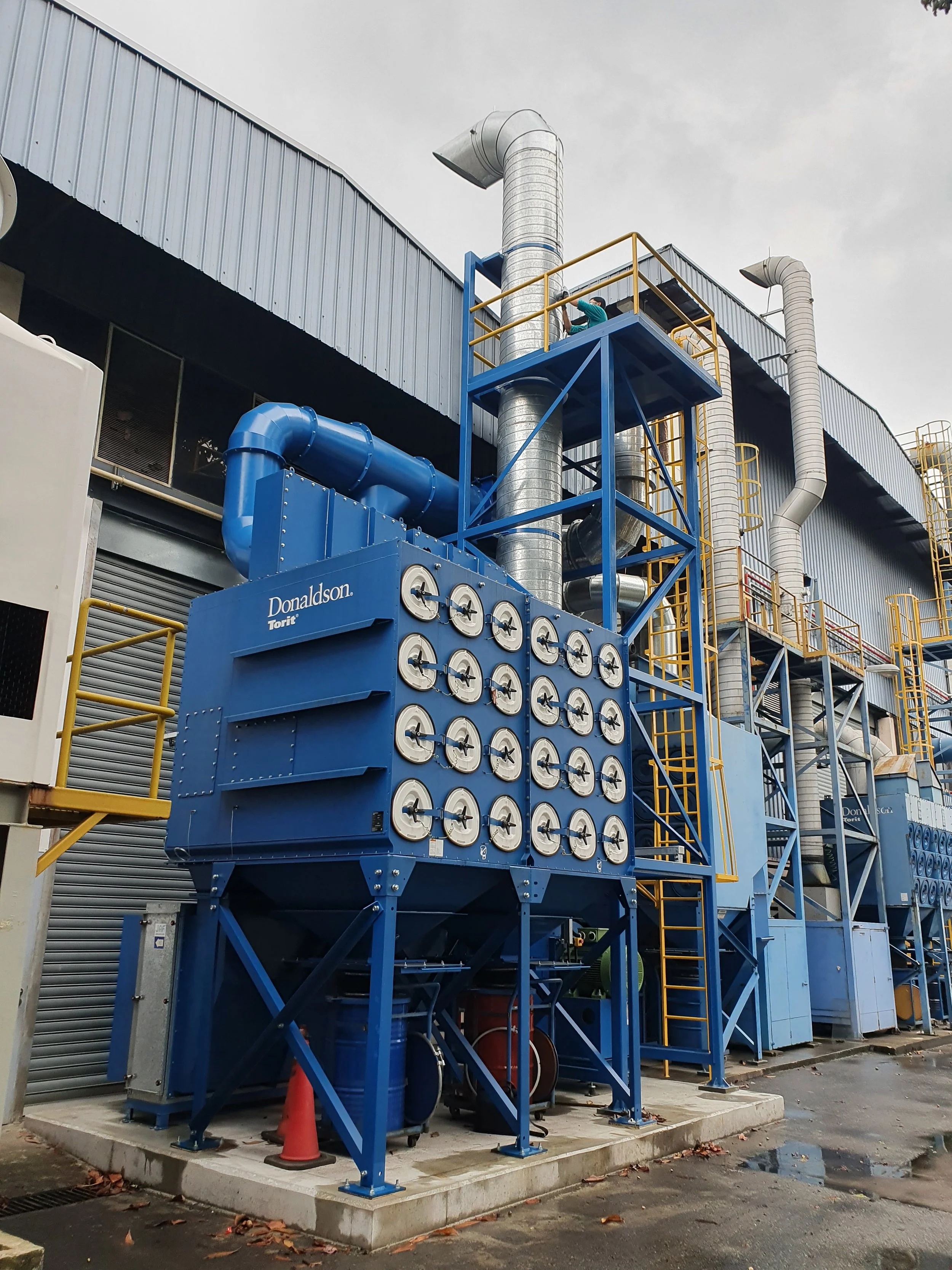 Explosion protected dust collector serving a thermal spray facility