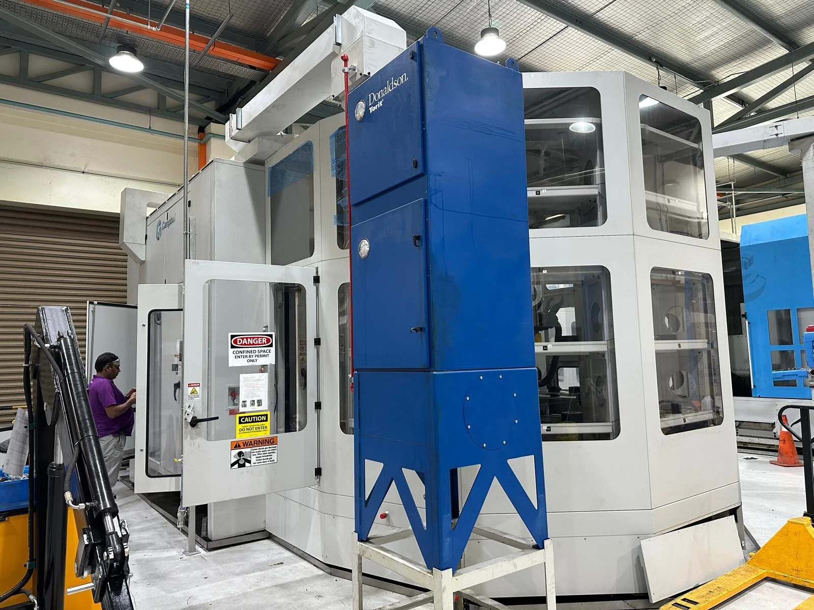 Oil mist collector mounted on a CNC machine in a Singapore workshop