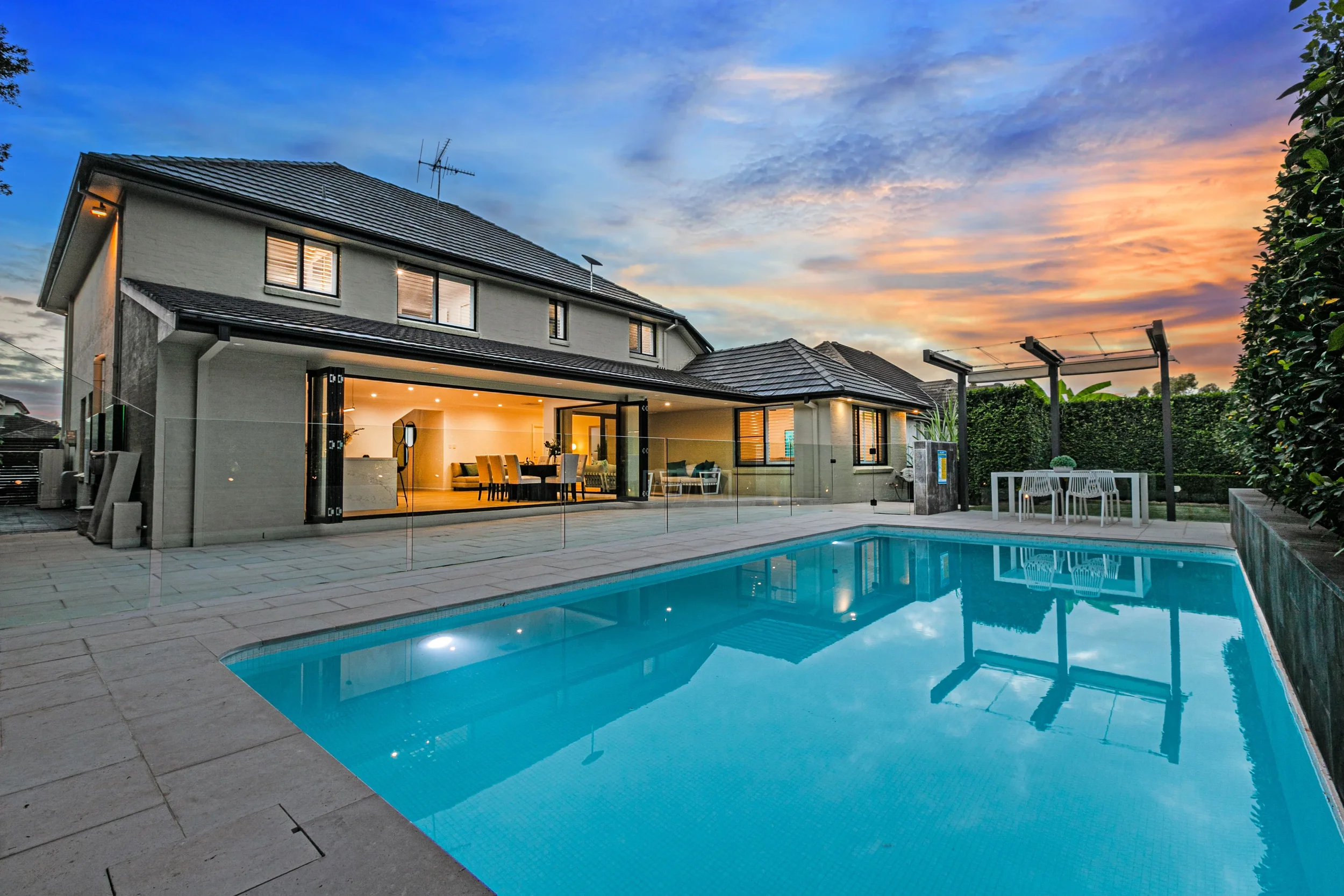 Frameless glass pool fence with hidden channel fixings and LED lighting