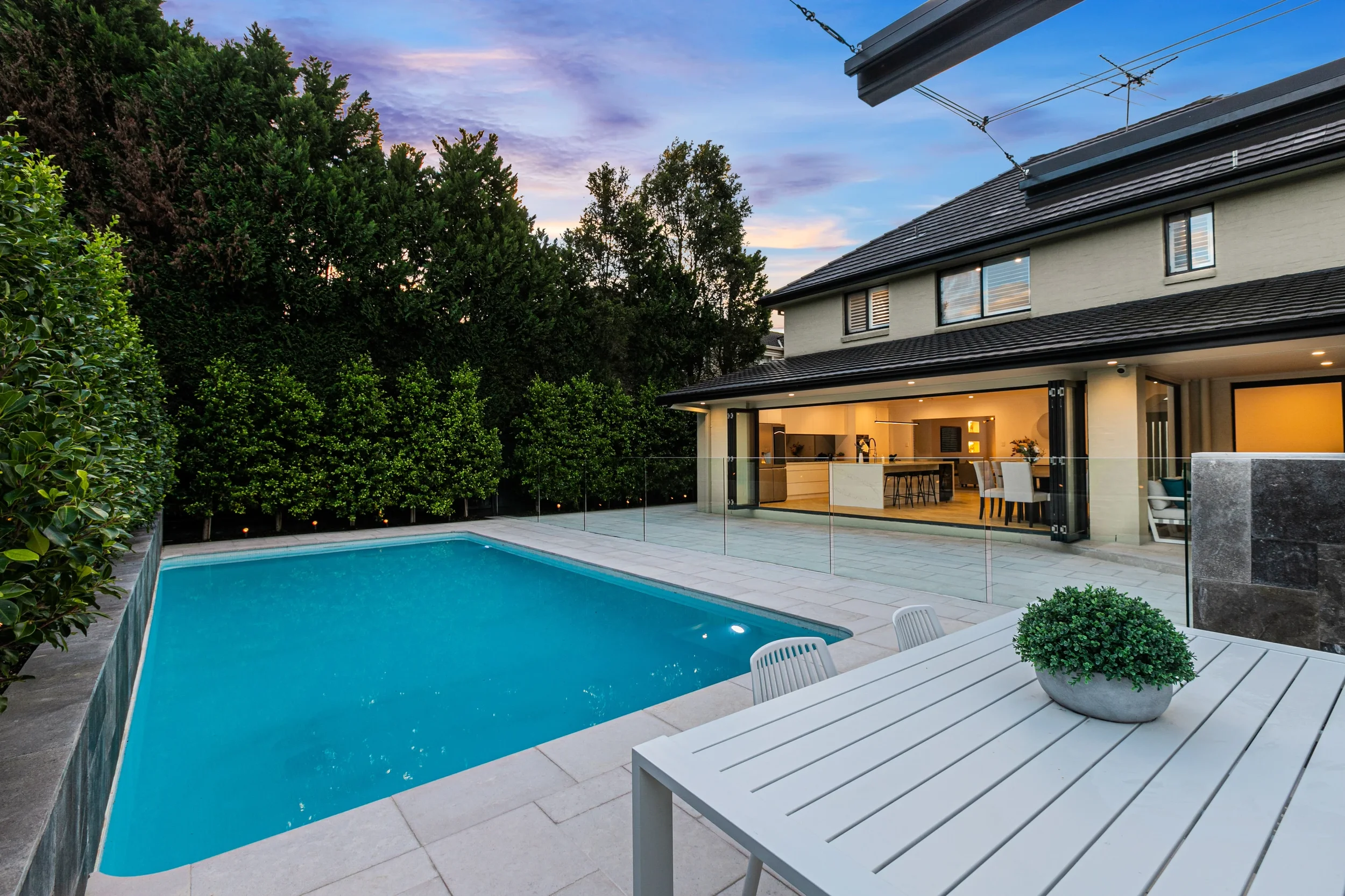 Frameless glass pool fence with hidden channel fixings and LED lighting