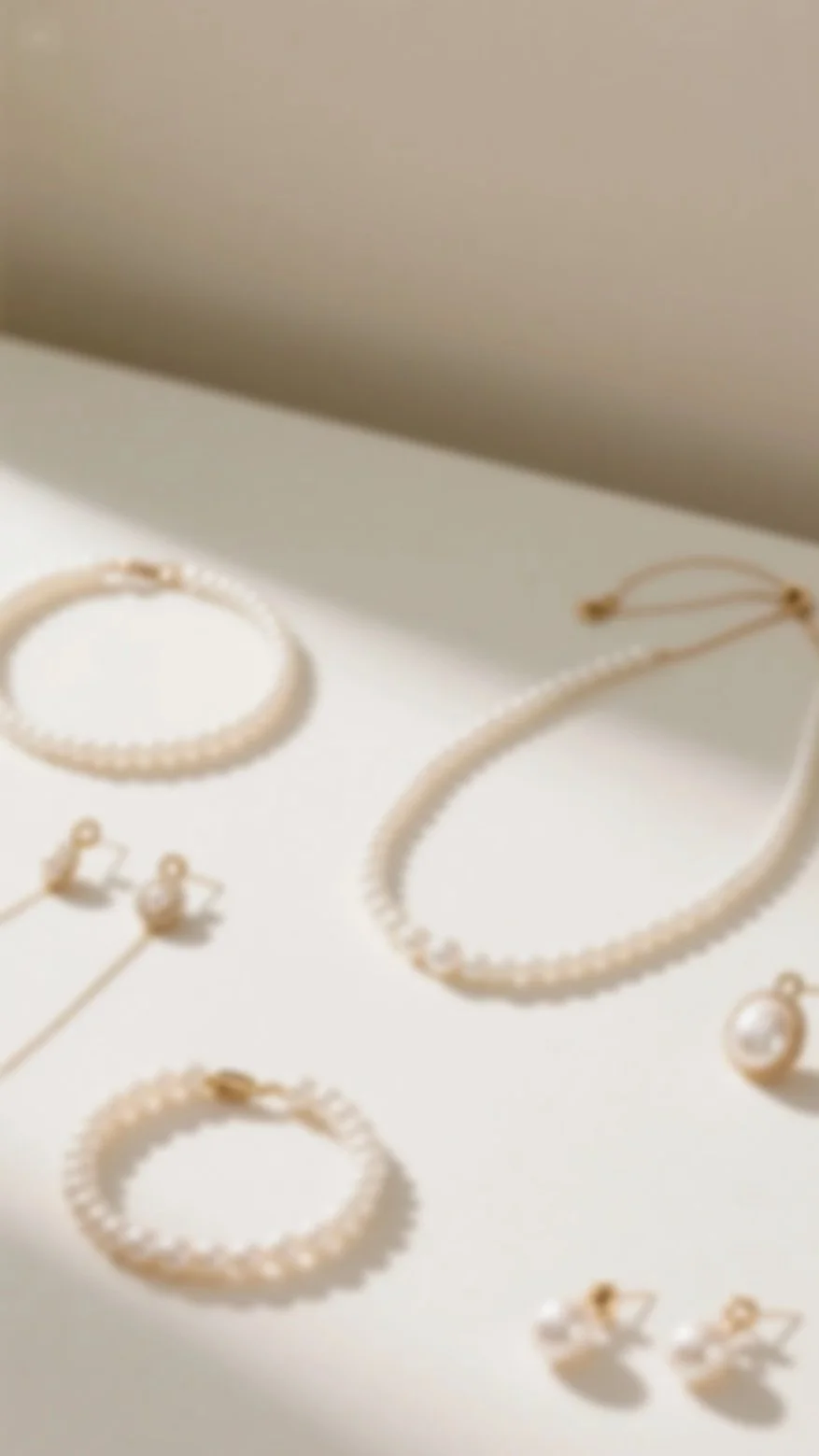 Collection of pearl jewelry including necklaces, earrings, and bracelets displayed on a white surface.