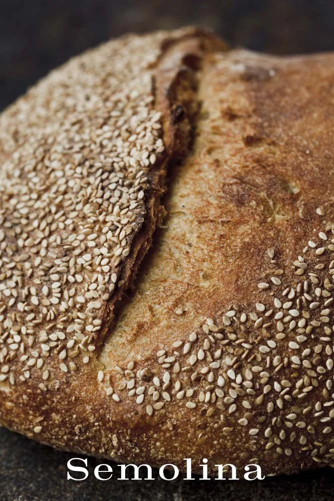 A loaf of bread topped with sesame seeds.
