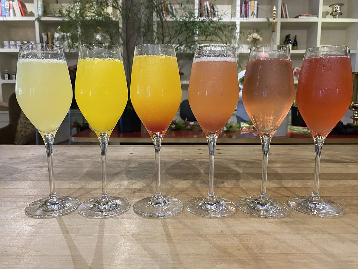 Six mimosas glasses in a row.