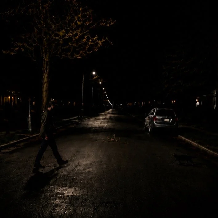 Nighttime road scene revealing a vehicle