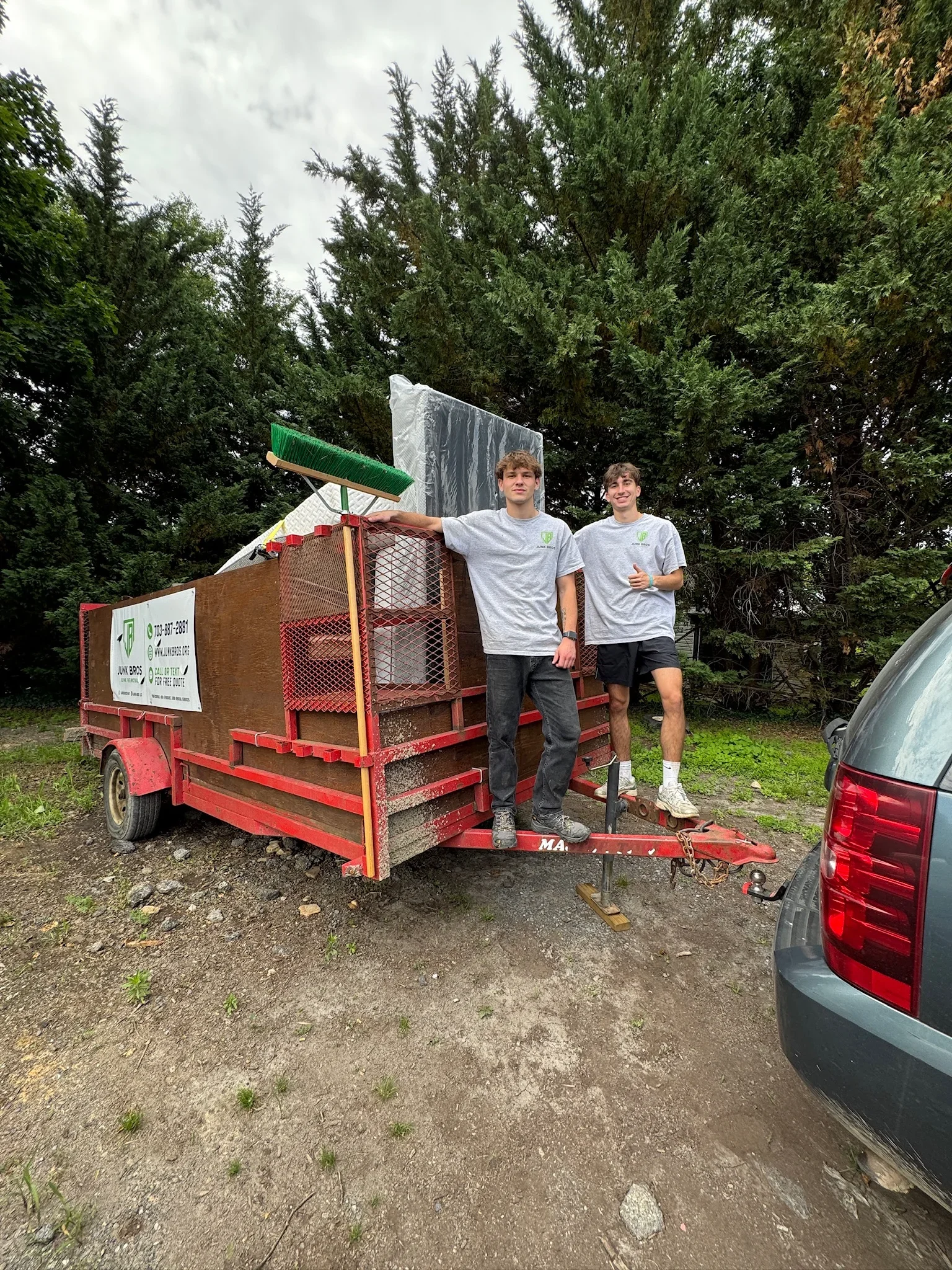 Junk Bros crew with loaded trailer after an apartment cleanout job at Middlebrook Apartments.