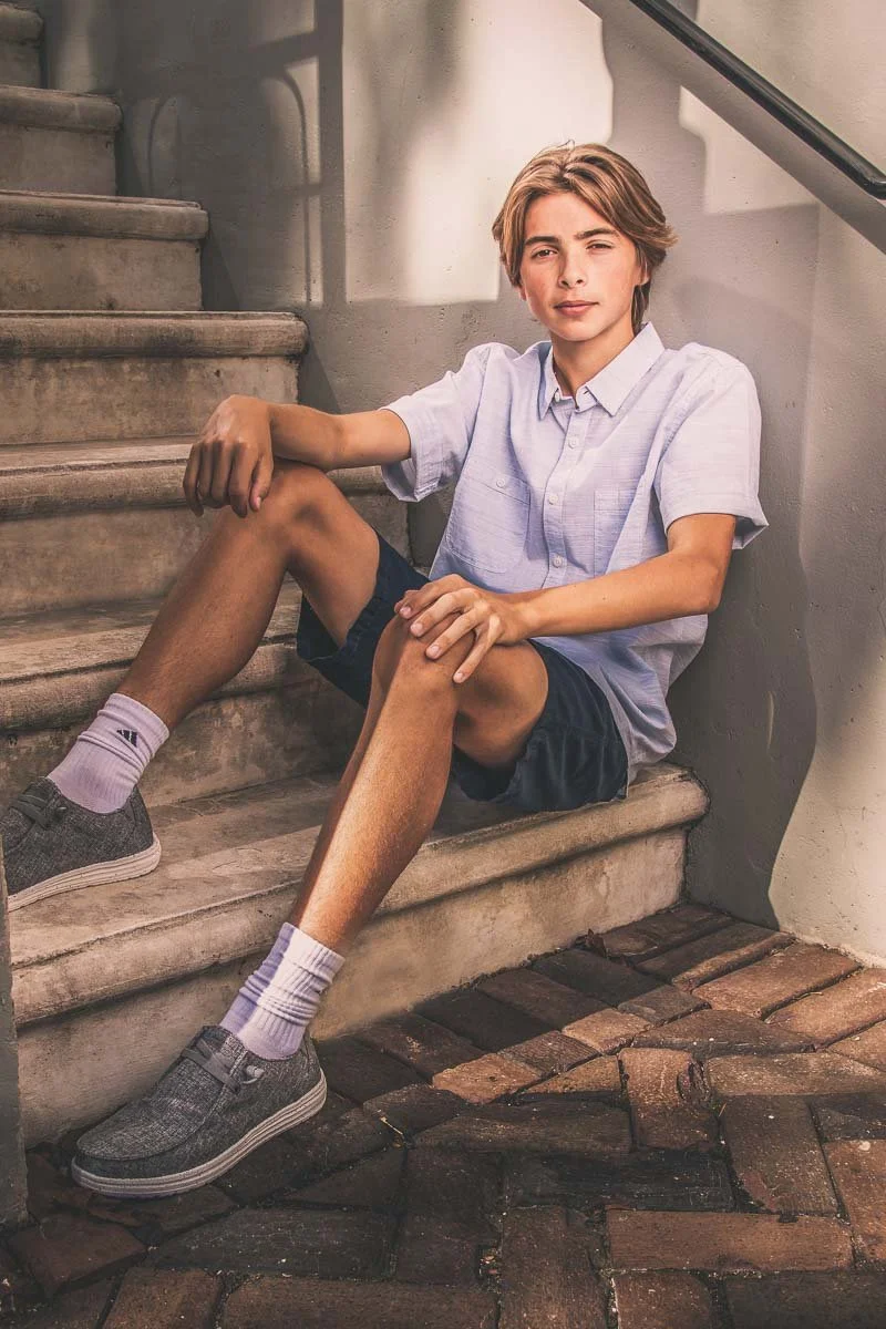 senior portrait of teenager sitting on outdoor steps
