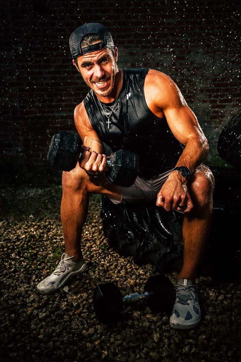 Sports portrait of athlete training with dumbbells