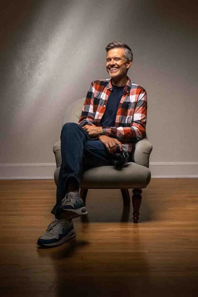 photographer smiling while sitting in a chair