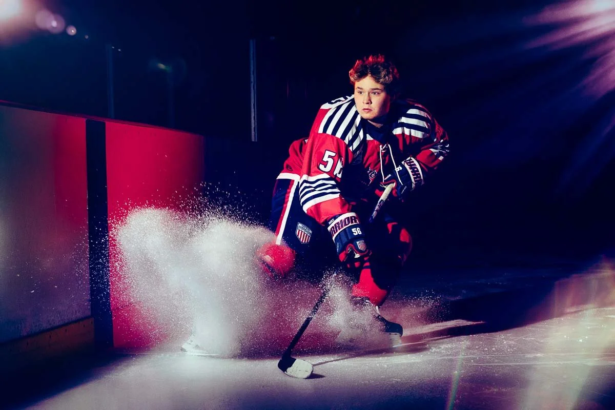 High school hockey player skating portrait with dramatic lighting
