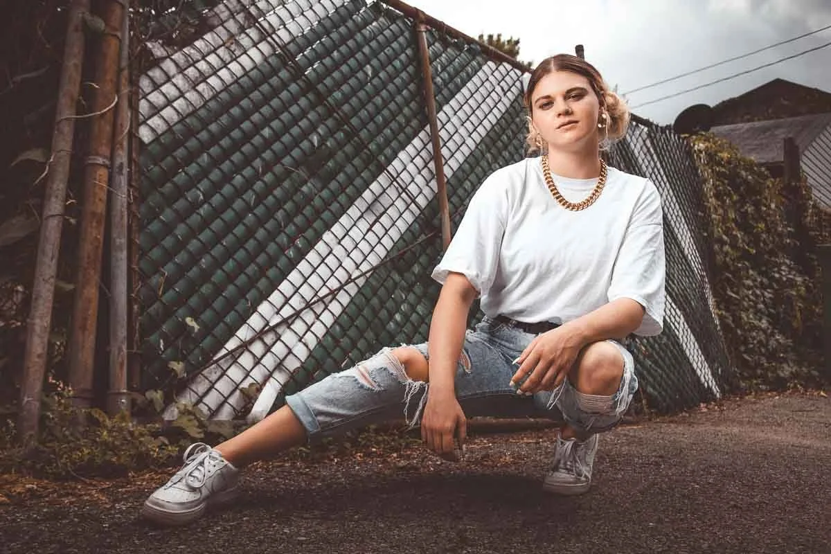 female posing in front of a fence for branding session
