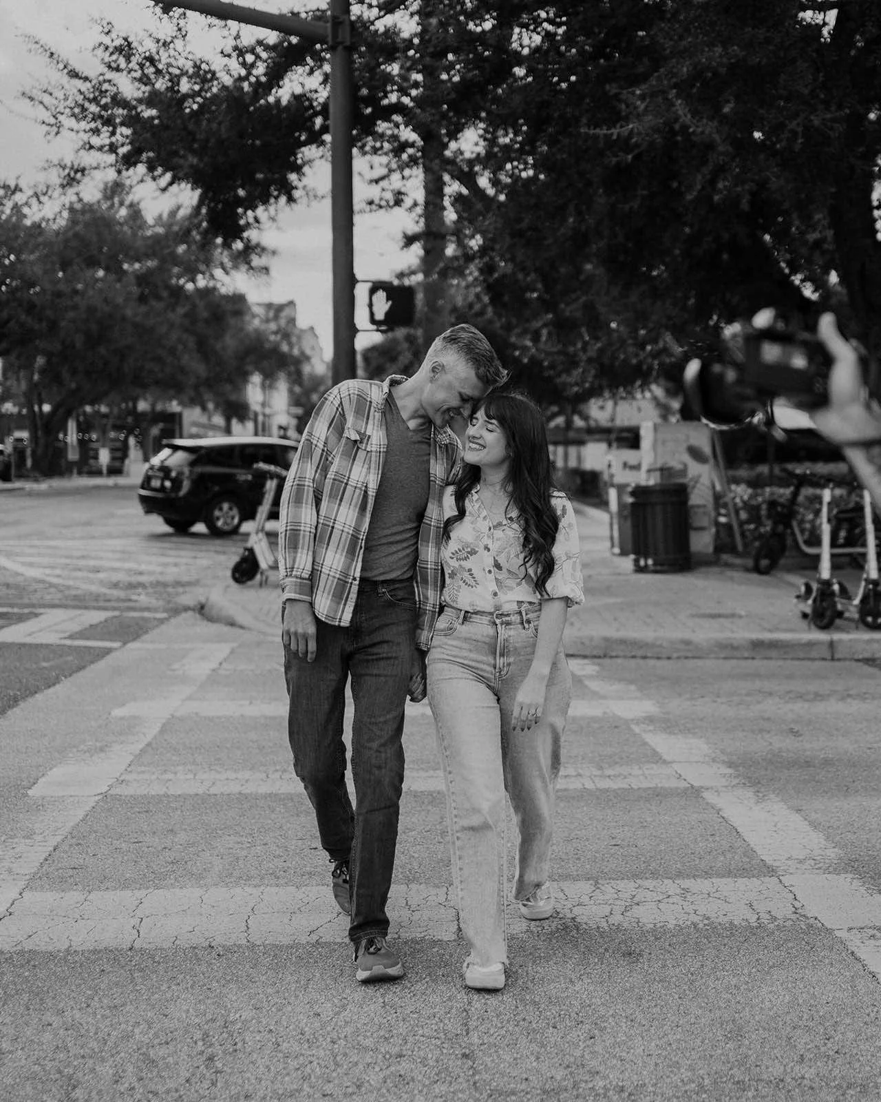 couple being playful walking across the street in Florida