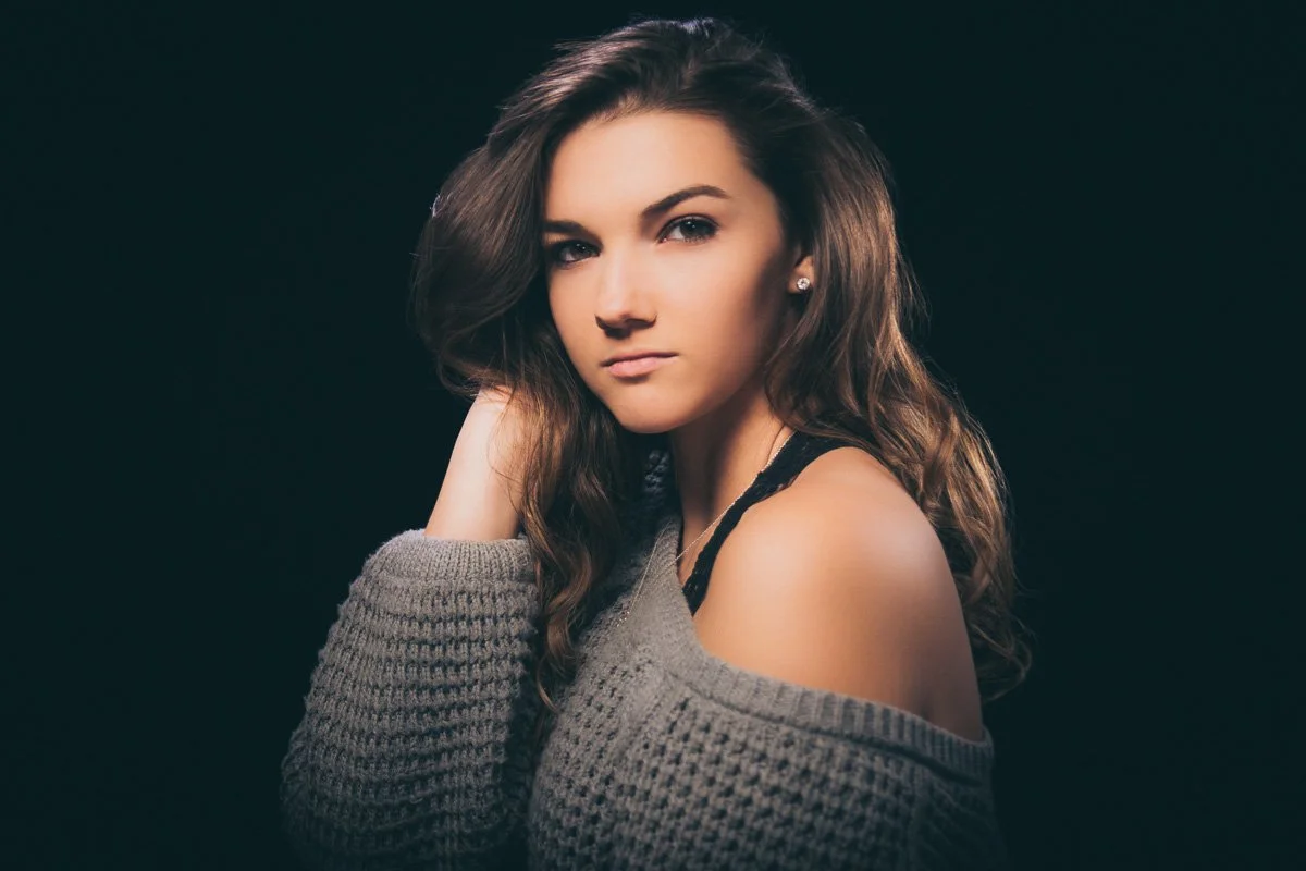 Editorial style portrait senior portrait in studio with lighting