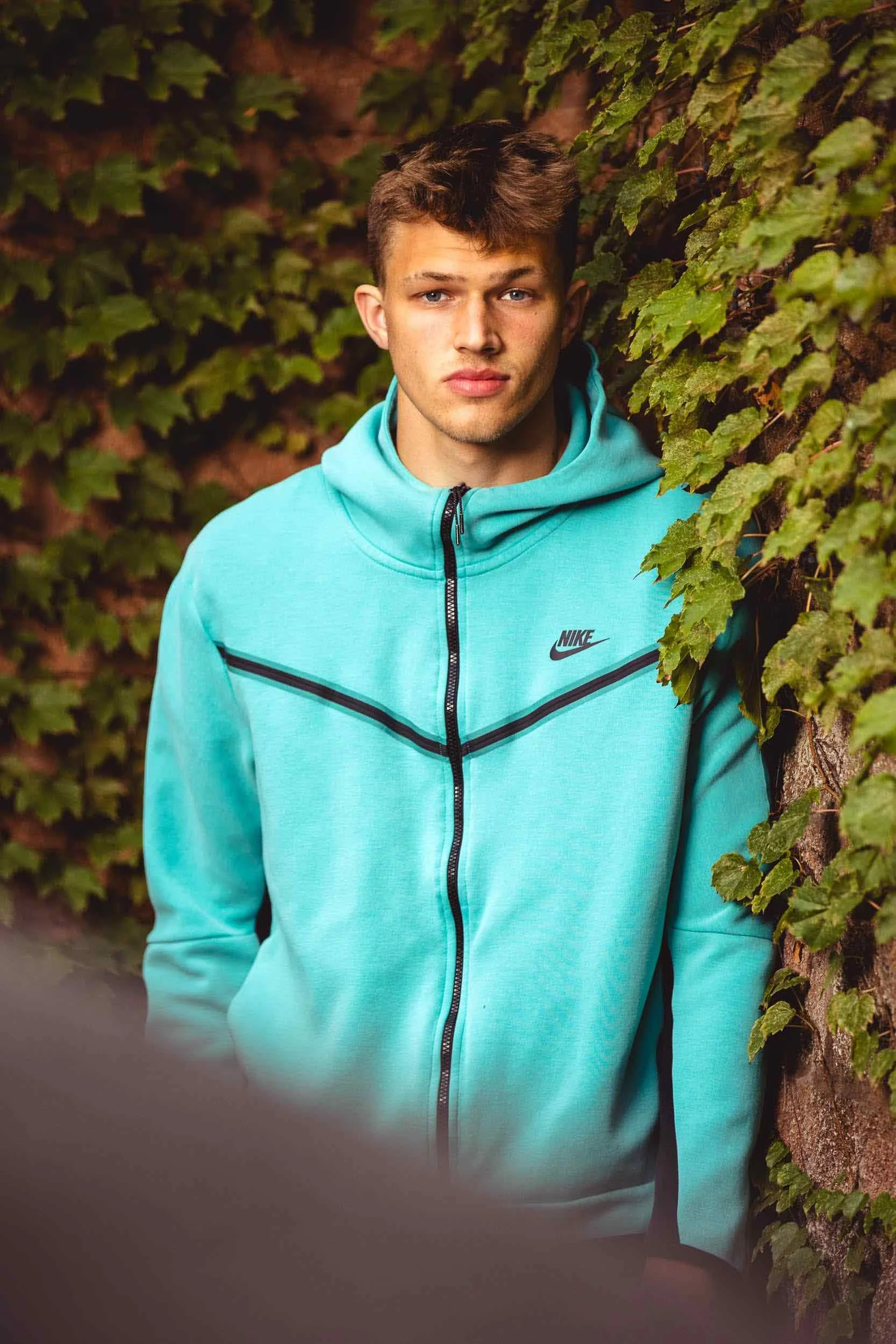 High school senior portrait outdoors with Nike jacket