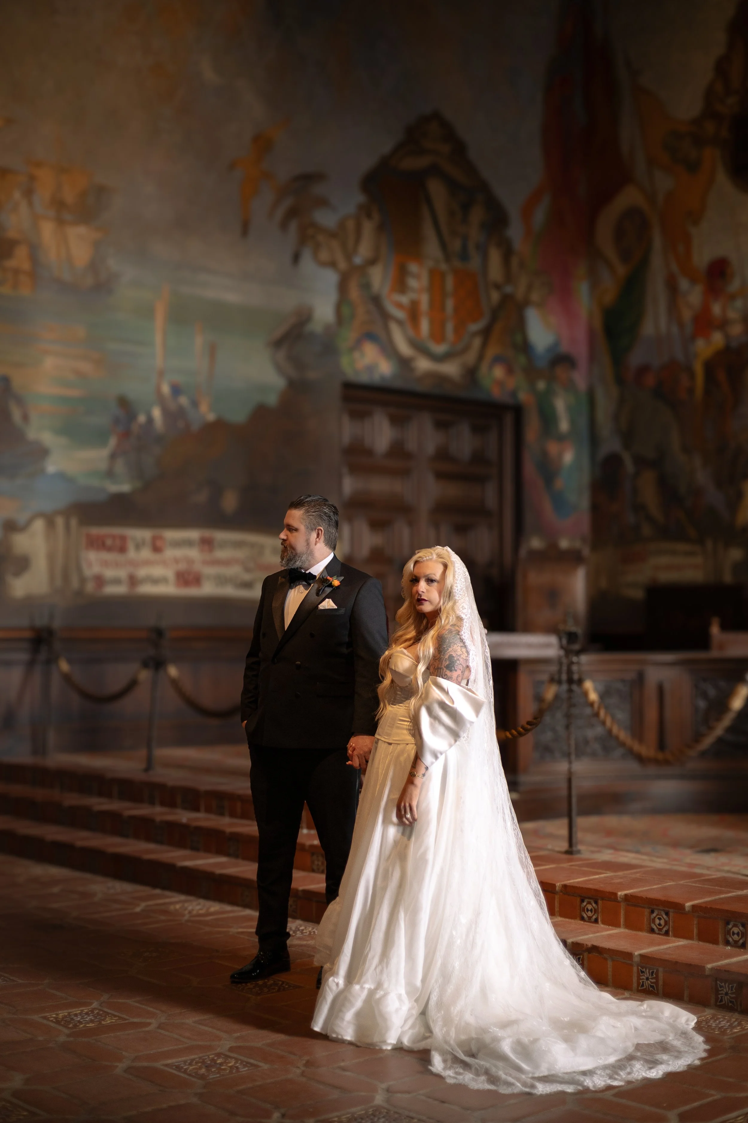 A couple dressed in wedding attire standing in a Santa Barbara wedding venue