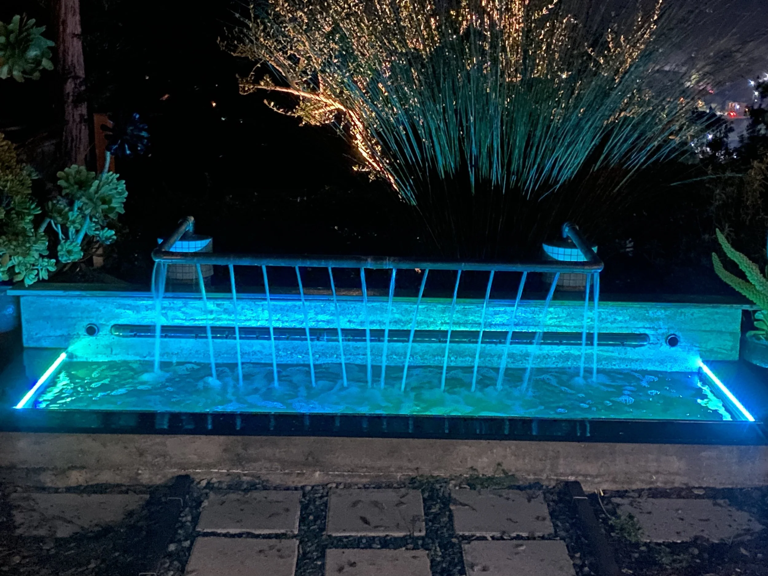 Concrete, re-used copper solar panels, and LED light adjustable water feature