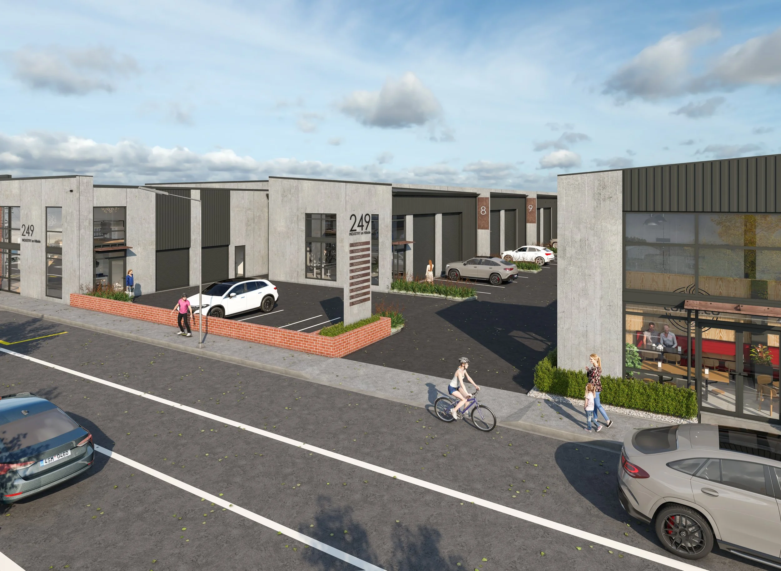 A modern commercial complex with parking lot, pedestrians, and a cyclist under a partly cloudy sky.