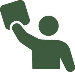 Silhouette of a person holding a ballot or sign up in the air.