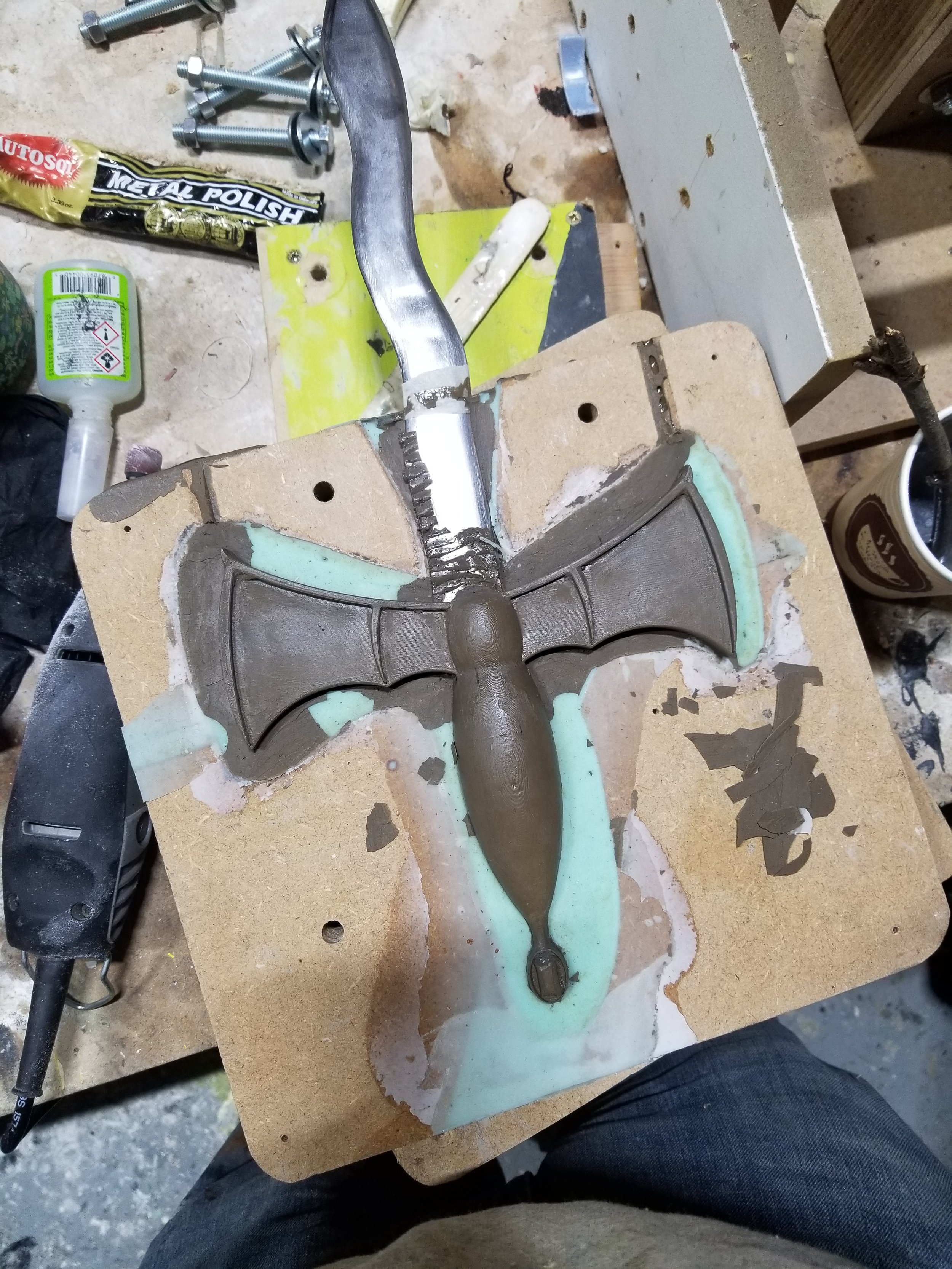 Hilt cast using cold cast bronze with steel blade inserted.