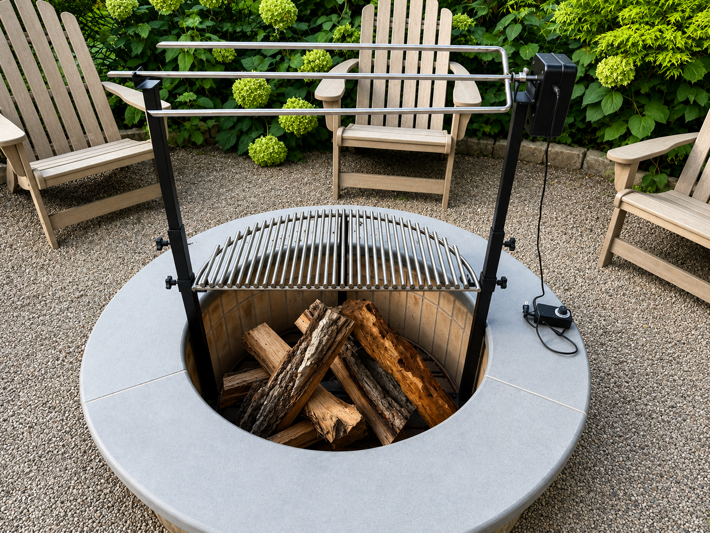 A fire pit with logs inside, surrounded by a concrete seating area, with a grill and heating element above, outdoors on a pebble ground with wooden chairs and green plants in the background.