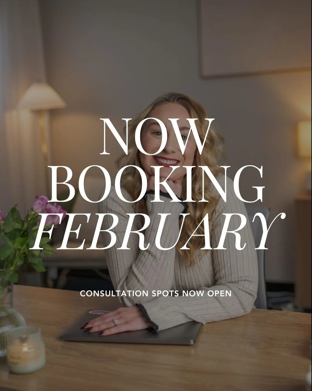 A smiling woman with blonde curly hair sitting at a desk in a well-lit room with a lamp, a laptop, and a flower vase, with overlay text that reads 'Now Booking February' and 'Consultation spots now open'.
