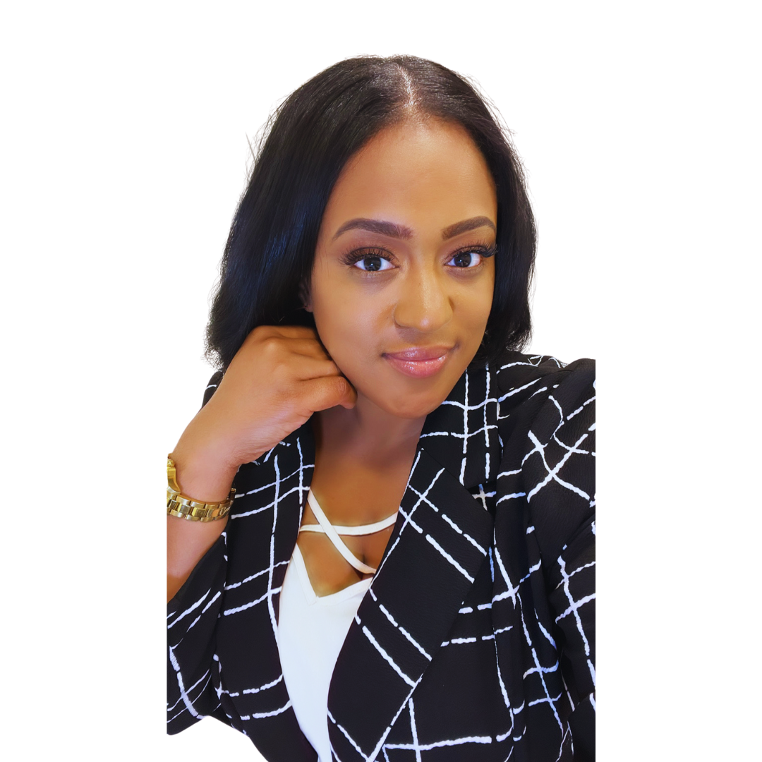 Portrait of a woman with black hair, wearing a black and white checkered blazer and a white top, smiling at the camera with her hand resting on her chin.