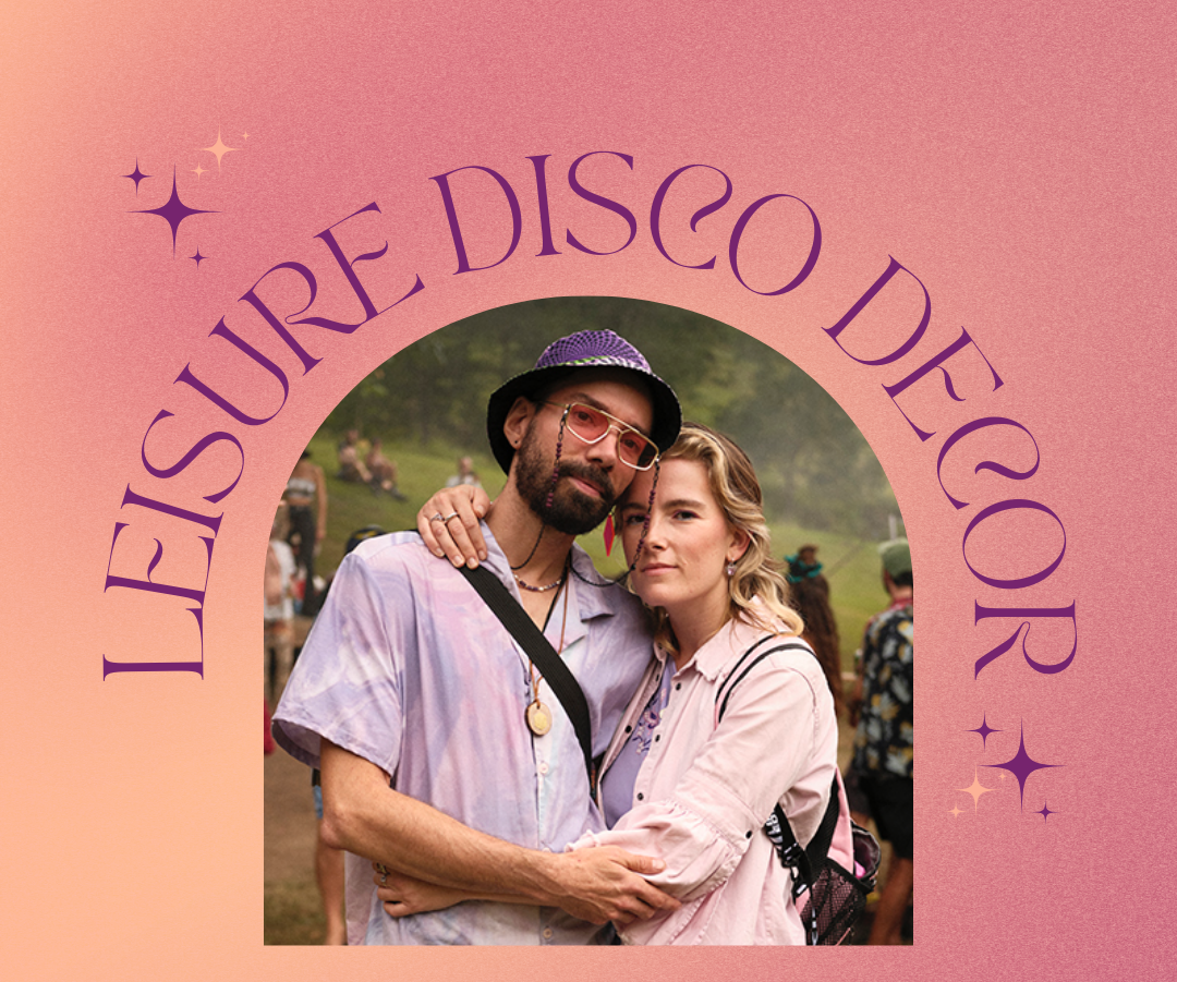 Two young adults, a man and a woman, embracing outdoors at a music festival with a pink background and purple text that reads "Leisure Disco Decor."