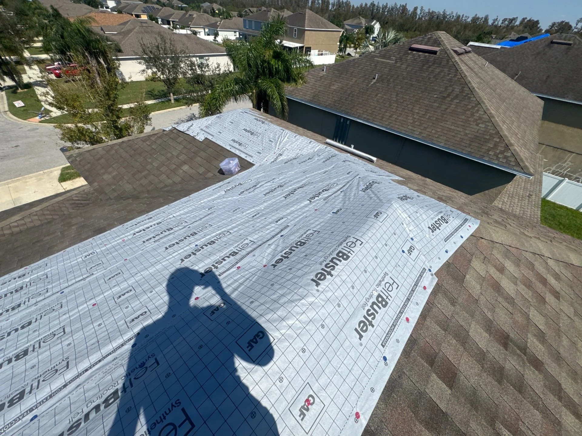 Residential roof that has been tarped before we get started on the roof replacement.