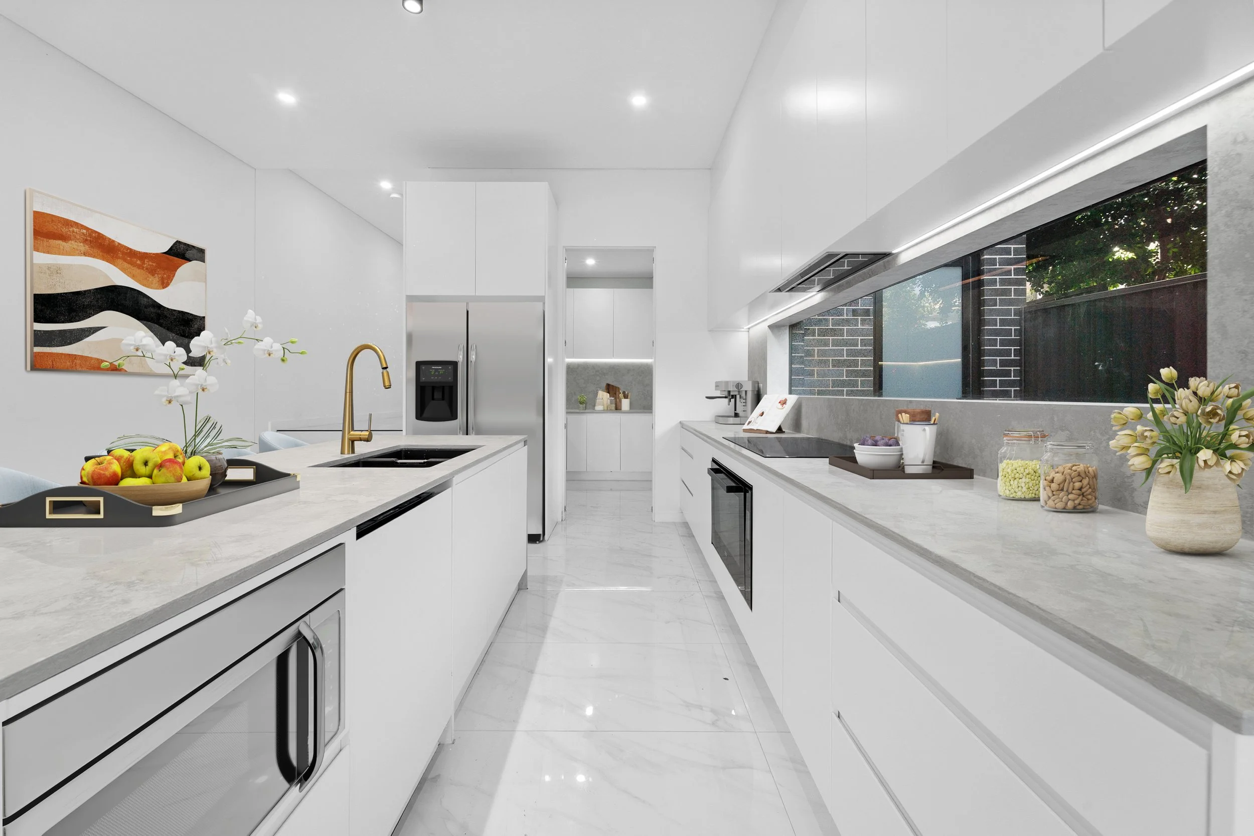 Modern kitchen with white cabinetry, marble countertops, stainless steel appliances, large window, and decorative flower and fruit bowls.