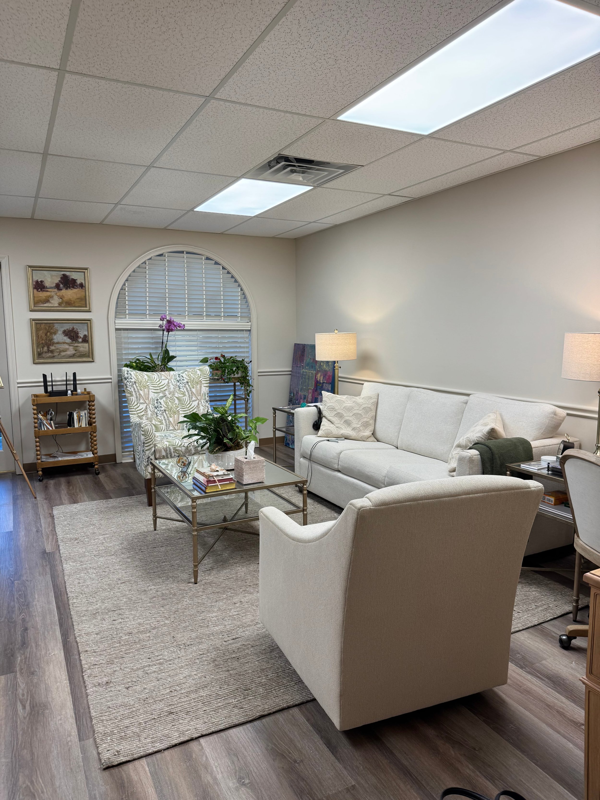 Warm, inviting counseling office with soft lighting and comfortable seating, representing a safe space for therapy sessions.