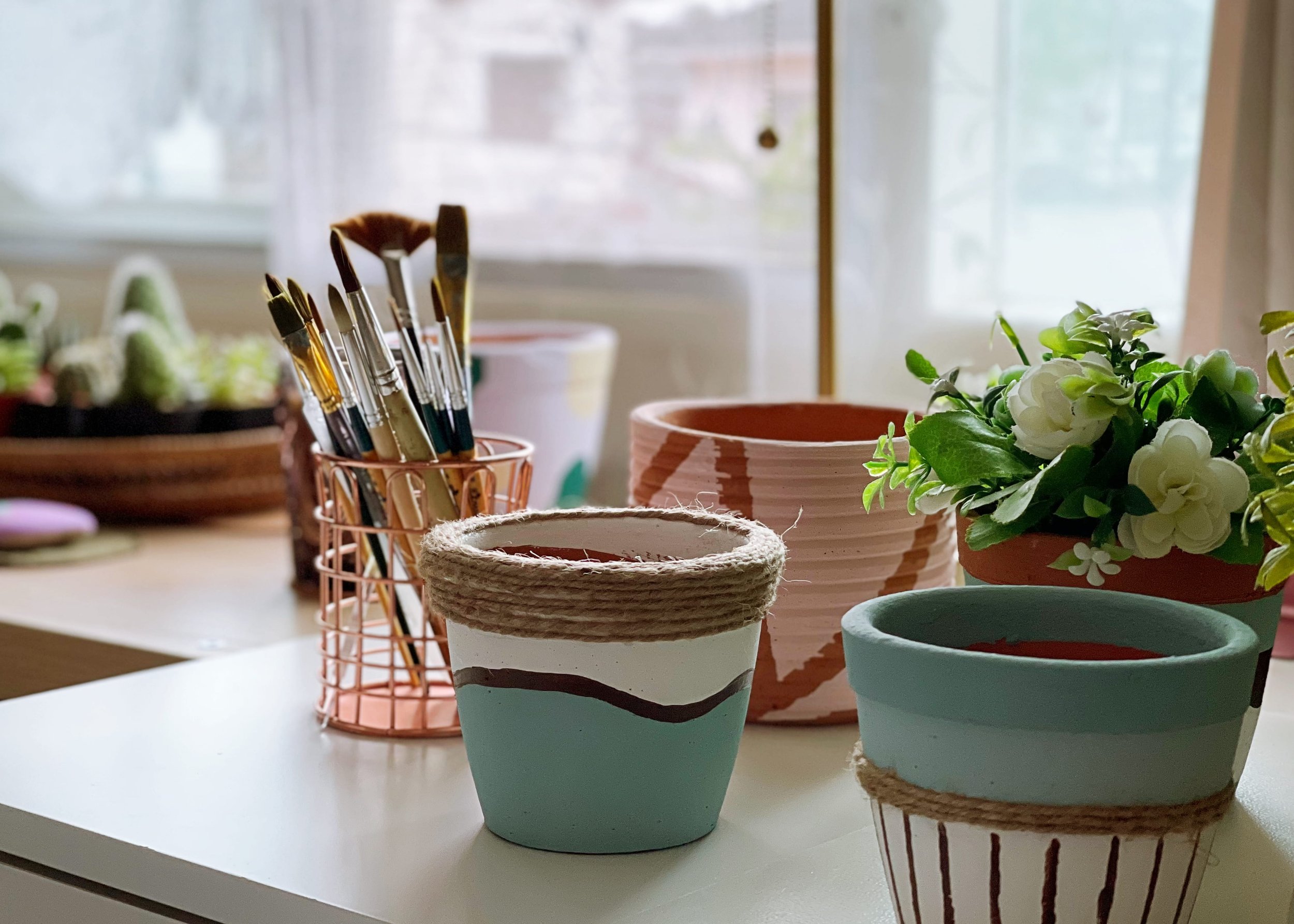 Table with art supplies and plants used for creative wellness and group therapy activities.