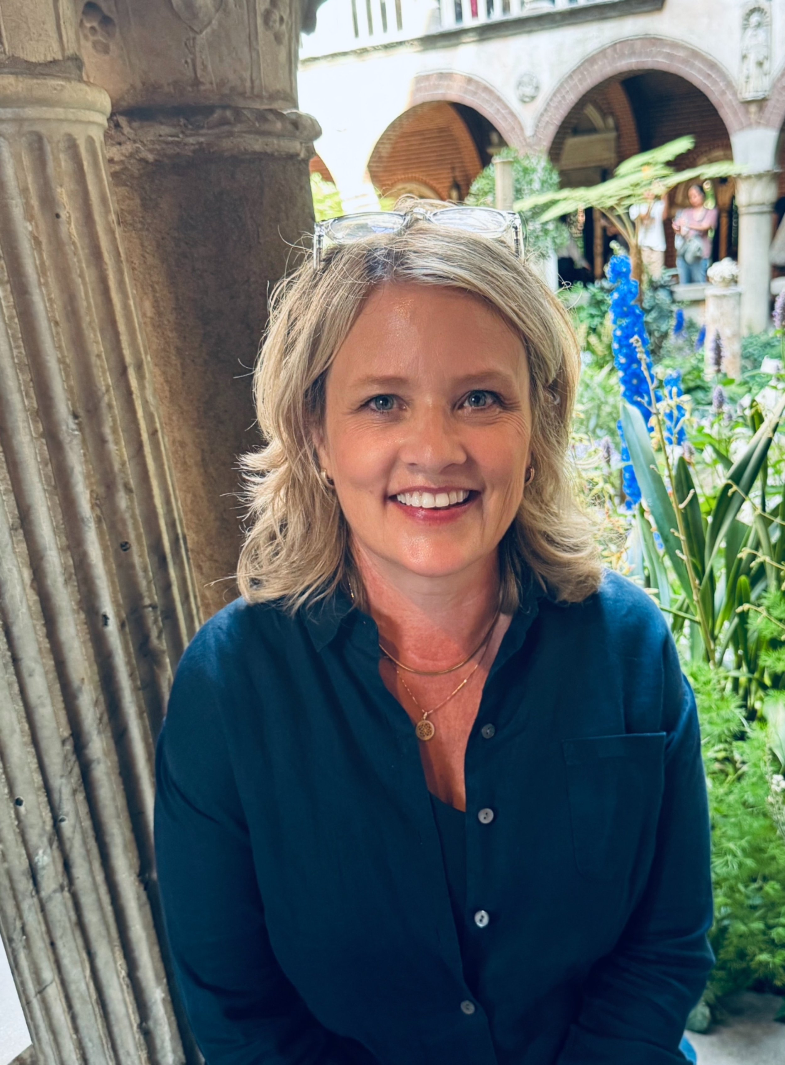 Michaelene McGinnis, licensed counselor and trauma therapist, smiling outdoors on St. Simons Island, GA.