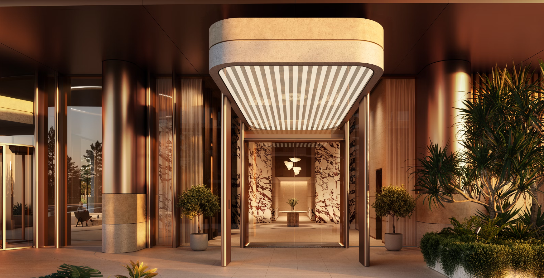 Modern building entrance with glass walls, marble accents, potted plants, and indoor lighting.