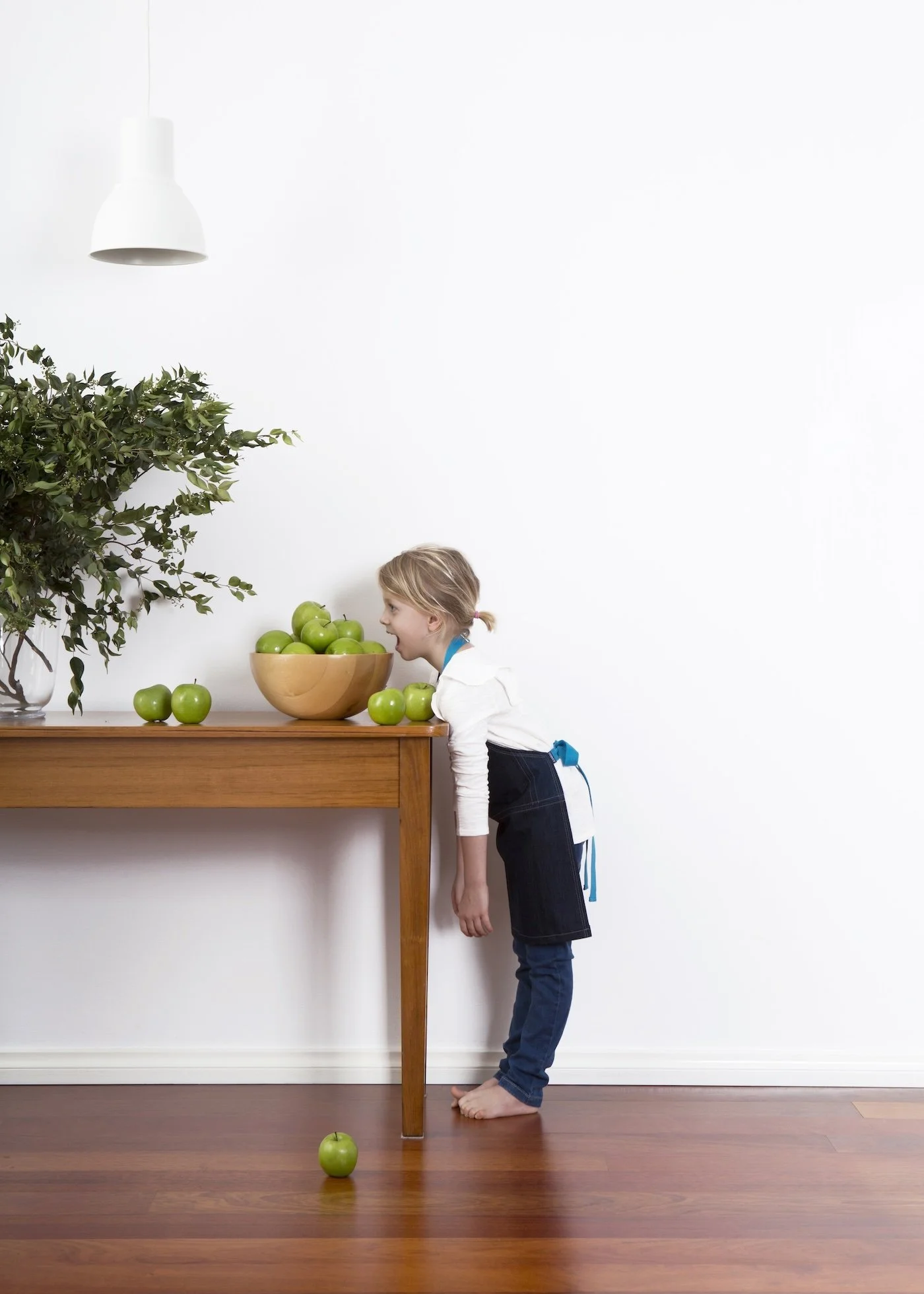  Side view of a child's JEANBAG Petite Apron by KT Doyle, handmade from recycled denim