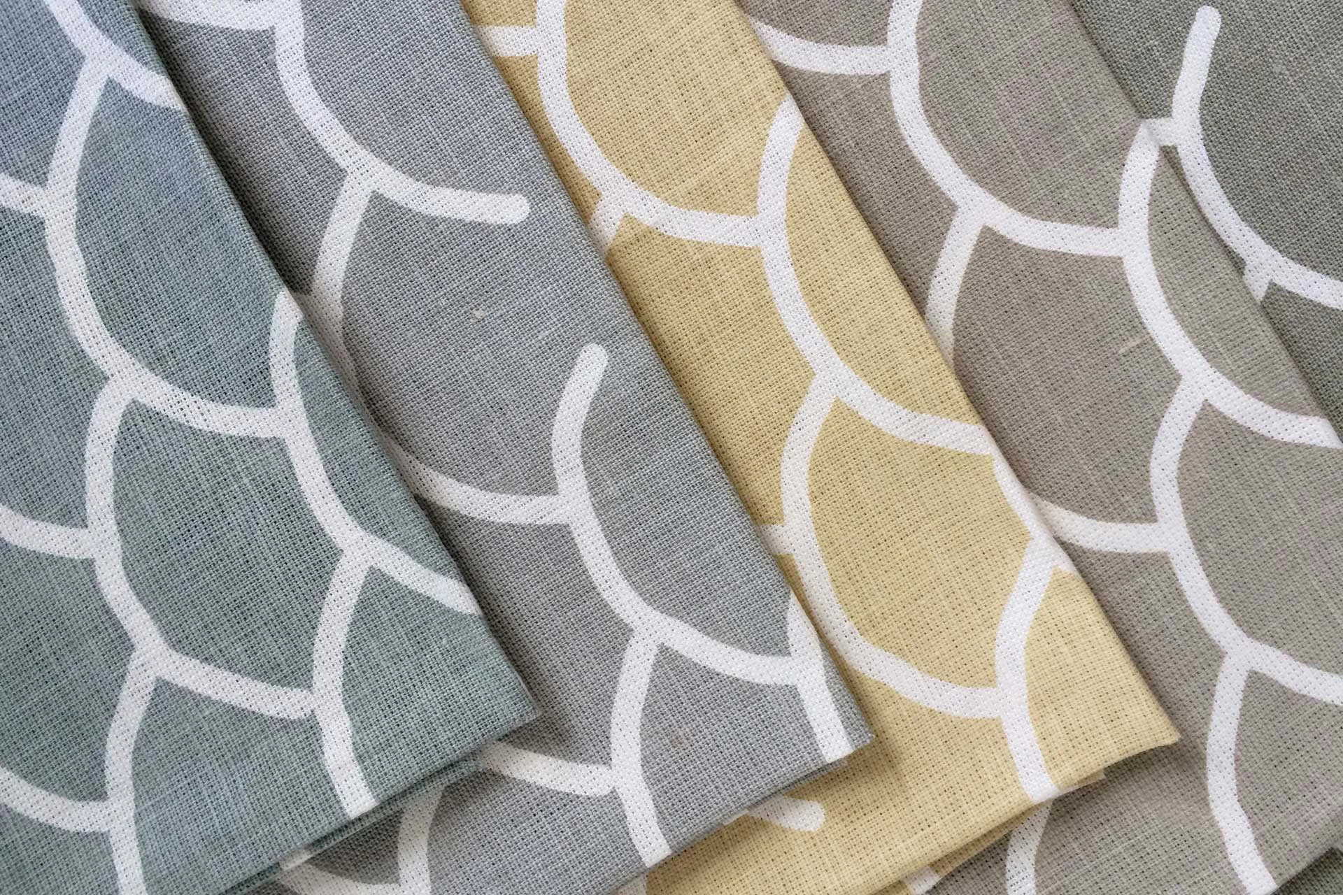 Detail of The Coolum Collection by KT Doyle for Hemptech, showing the shell-inspired pattern across folded linen textiles in coastal colourways