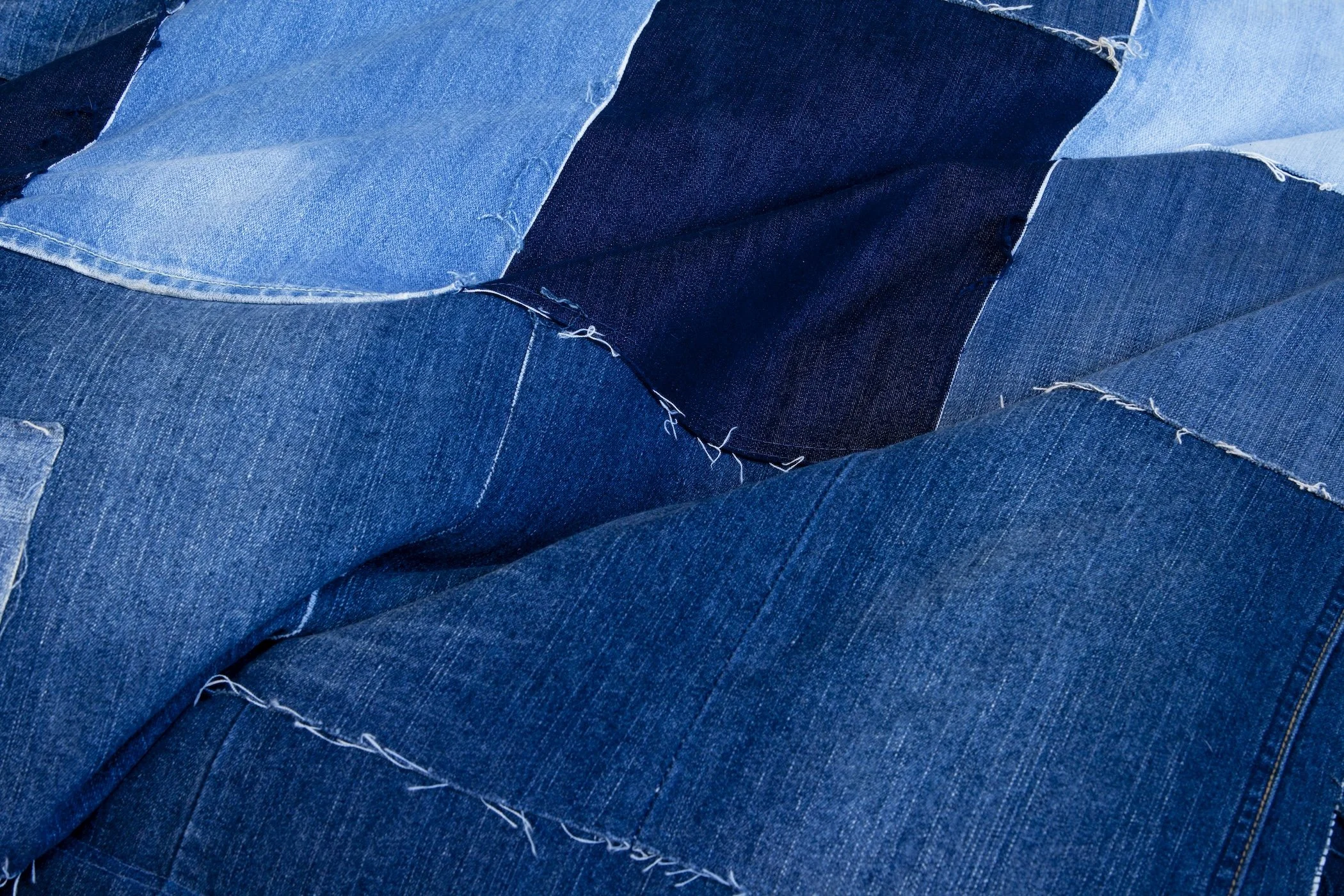 Detail of the Original JEANBAG showing patchworked recycled denim, exposed seams and contrasting washes