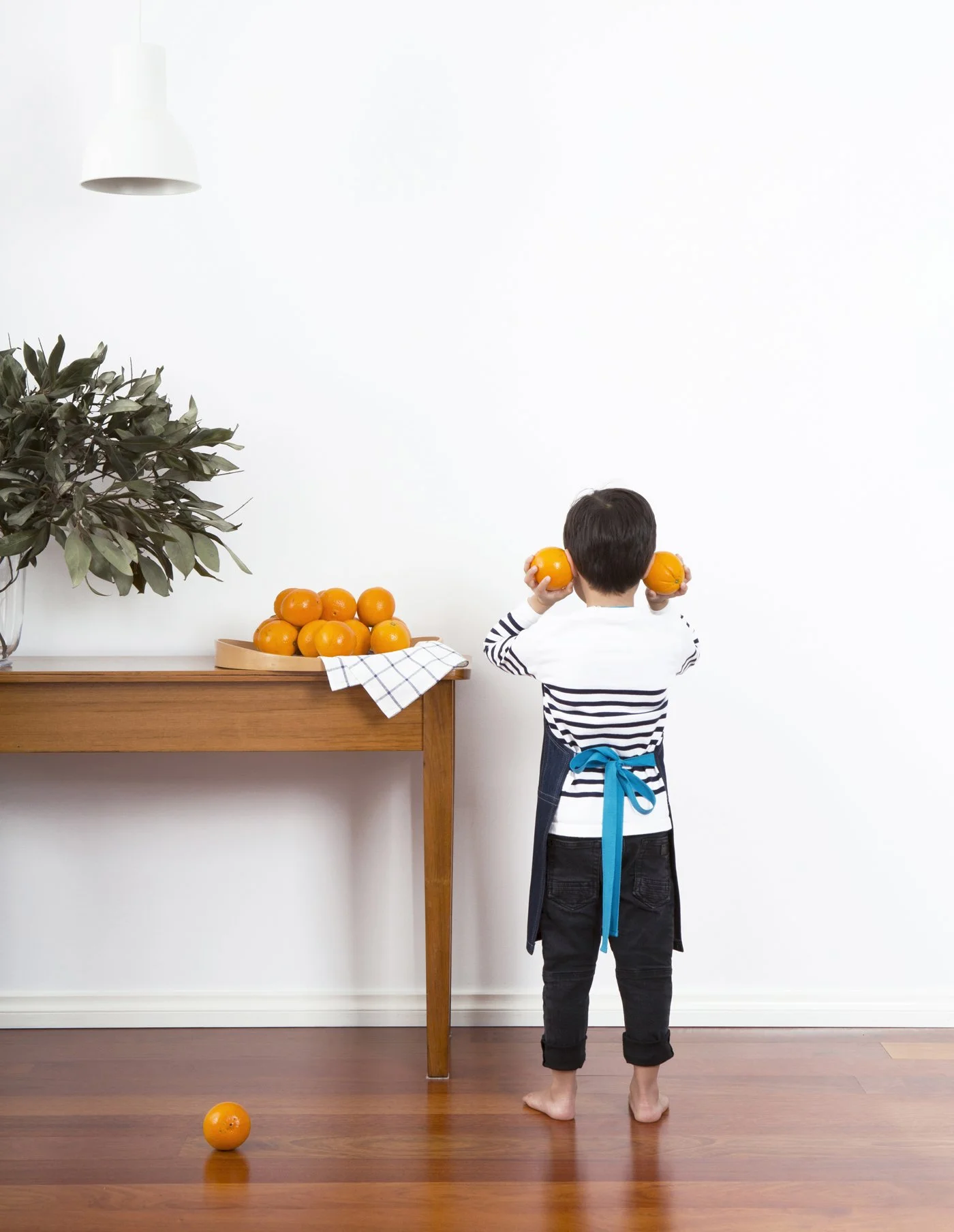 Back view of a child's JEANBAG Petite Apron by KT Doyle, handmade from recycled denim