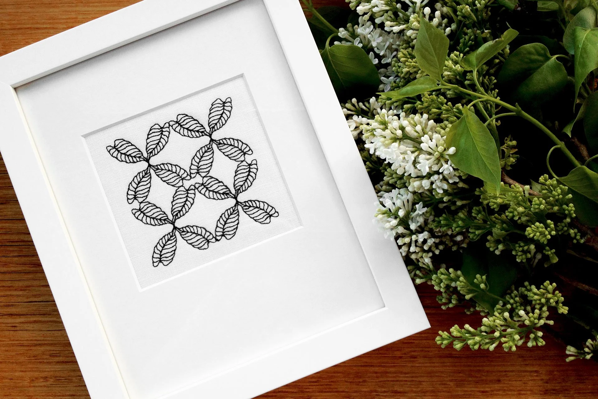 CP3 botanical embroidery from the Collected Patterns series by Australian artist KT Doyle, geometric Caladium leaf pattern stitched in black on white linen