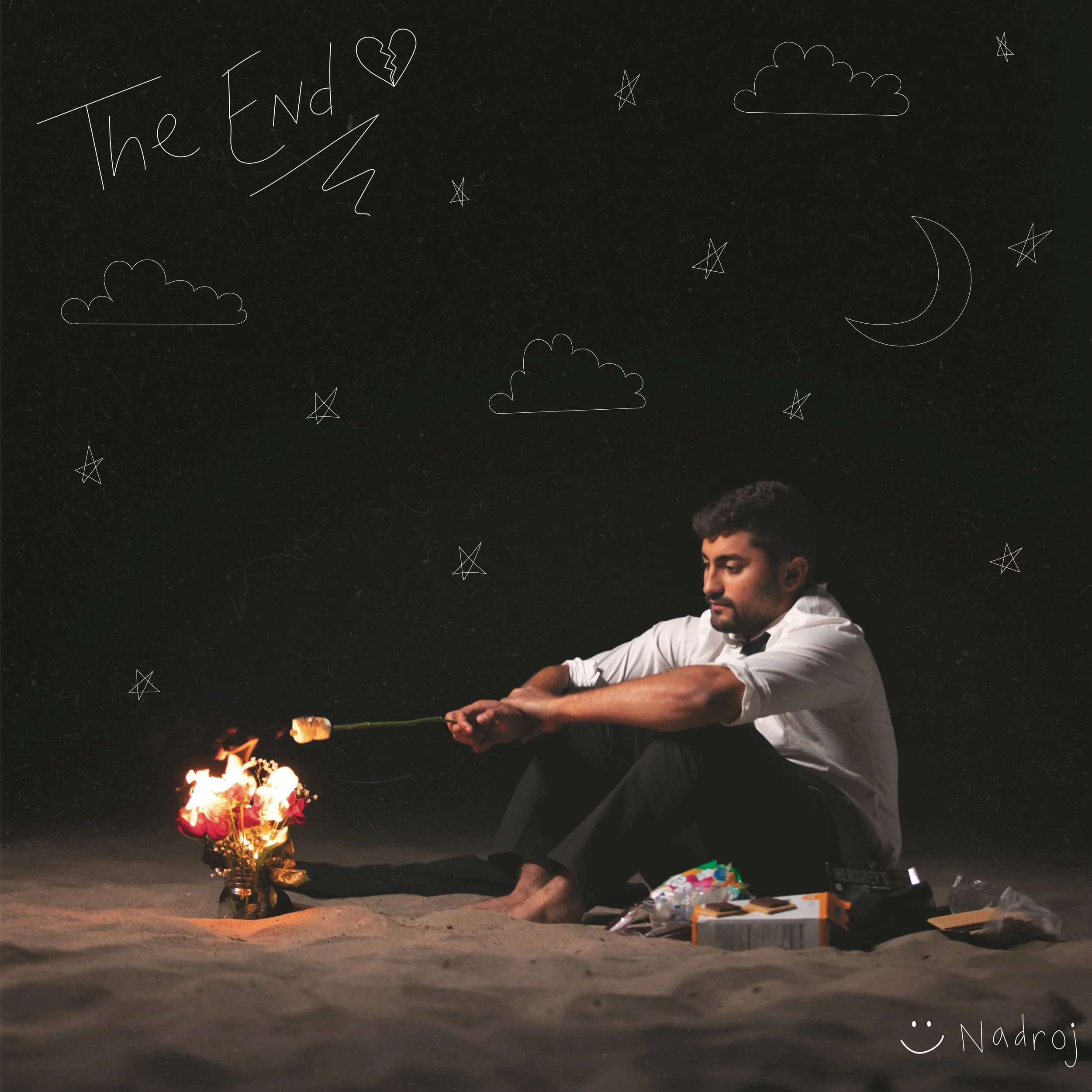 Nadroj cover art - in a white shirt and black pants sits on the ground at night, holding a  over a small fire. Nighttime with white doodles of clouds, stars, a moon, and a heart with a crack, and the words 'The End' written in the top left corner.