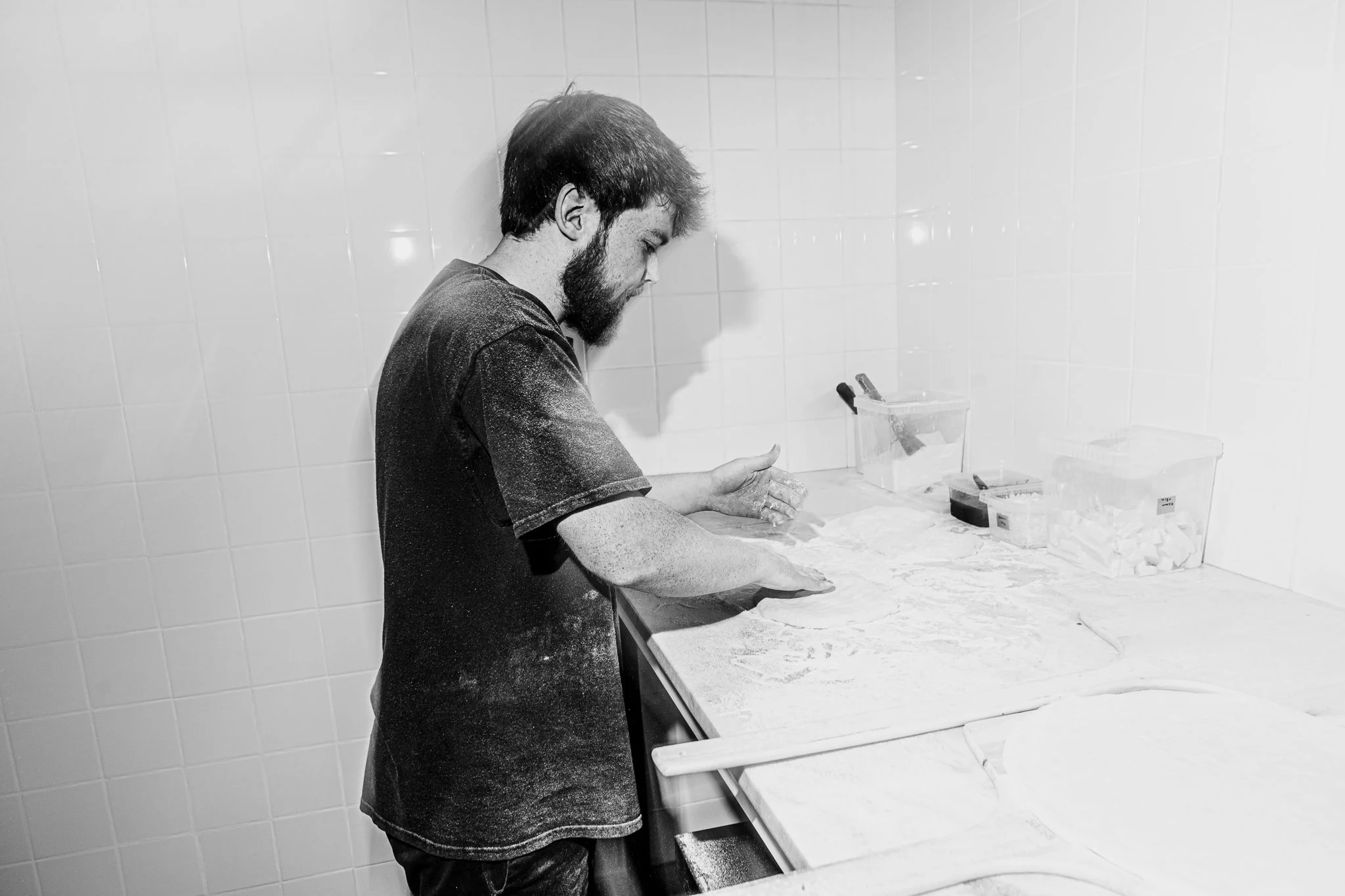 Personal chef stretching pizza dough